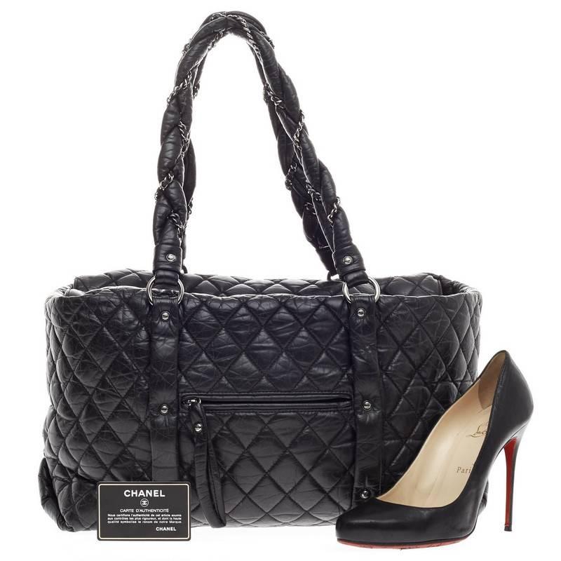 This authentic Chanel Ligne Lady Braid Tote Quilted Leather XL is perfect for the on-the-go fashionista for everyday use and light travel. Constructed from distressed black diamond quilted leather, this oversized tote features intertwined woven