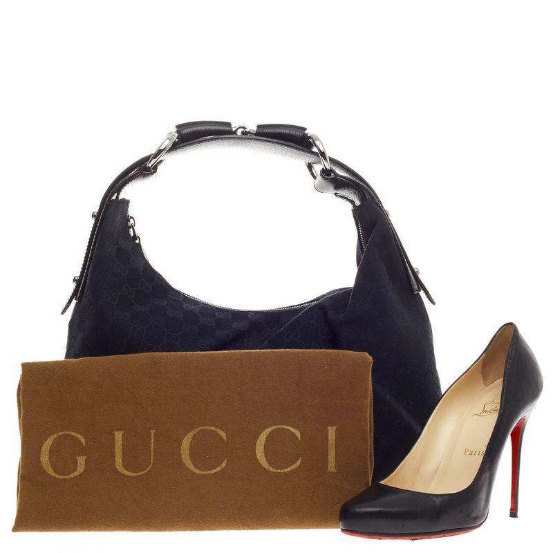 This authentic Gucci Horsebit Hobo GG Canvas Medium is classic and sophisticated perfect for everyday use. Crafted in black GG monogram canvas, this hobo features black leather trimmings, single loop shoulder strap with horsebit and ring accents,