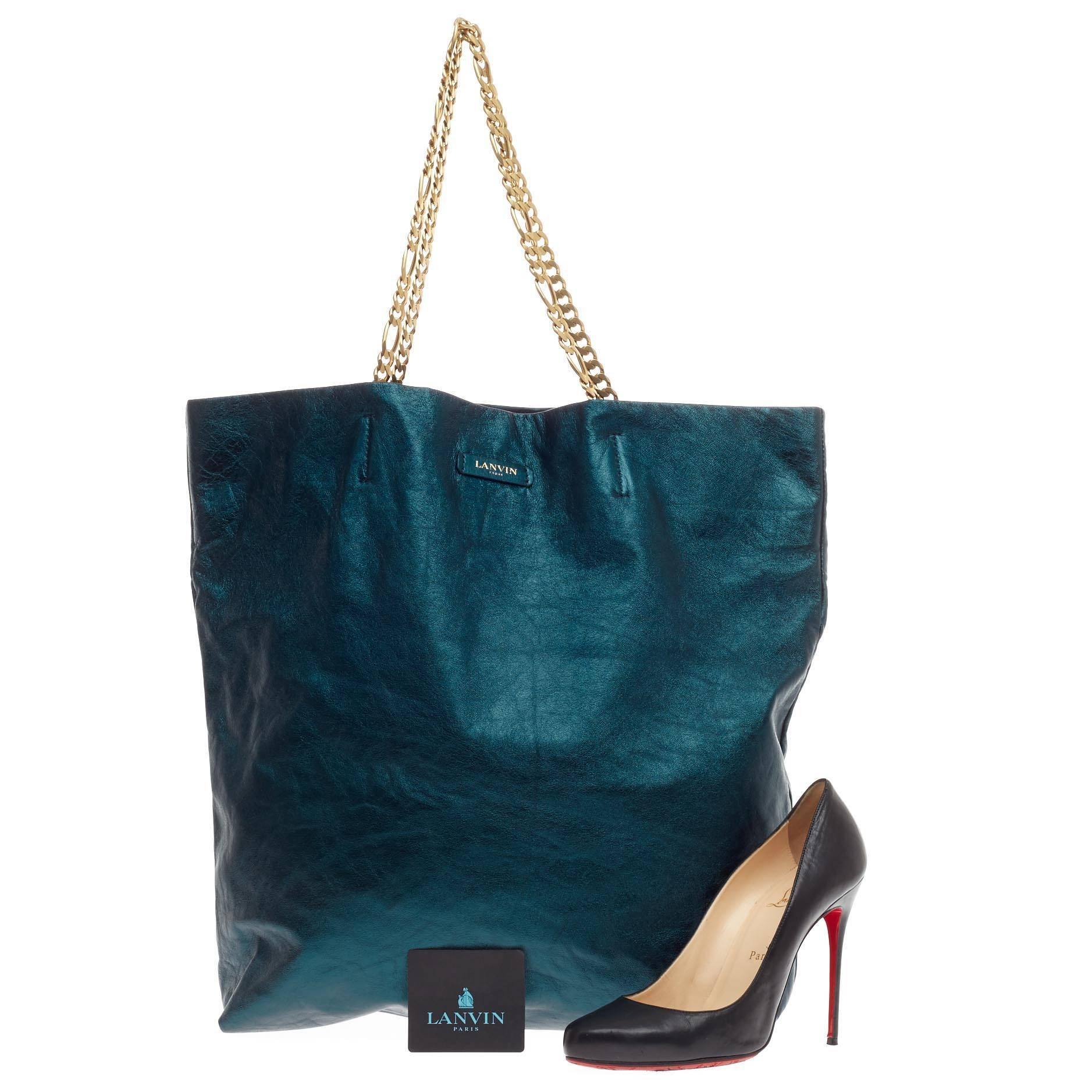 This authentic Lanvin Paper Bag Tote Metallic Lambskin Large presented in the brand's Spring/Summer 2014 Collection showcases a sophisticated, casual-luxe look made for the modern woman. Crafted from thin metallic blue lambskin crinkled leather with