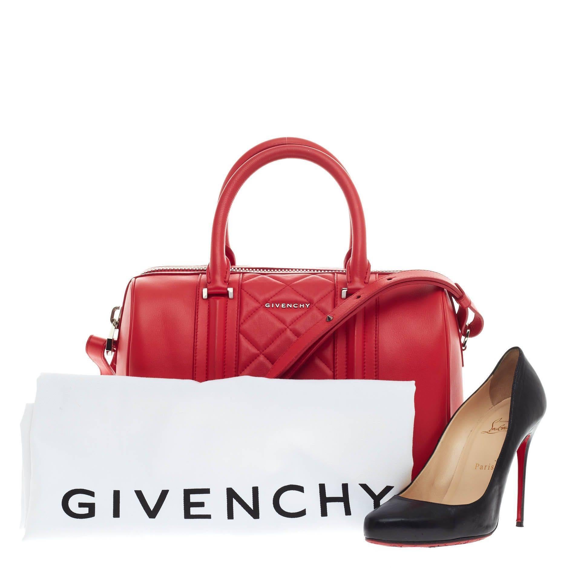 This authentic Givenchy Lucrezia Duffle Bag Quilted Leather Medium is one of the season's hottest bags perfect for the modern woman. Crafted from bright red orange quilted leather, this structured minimalist bowler bag features quilted diamond