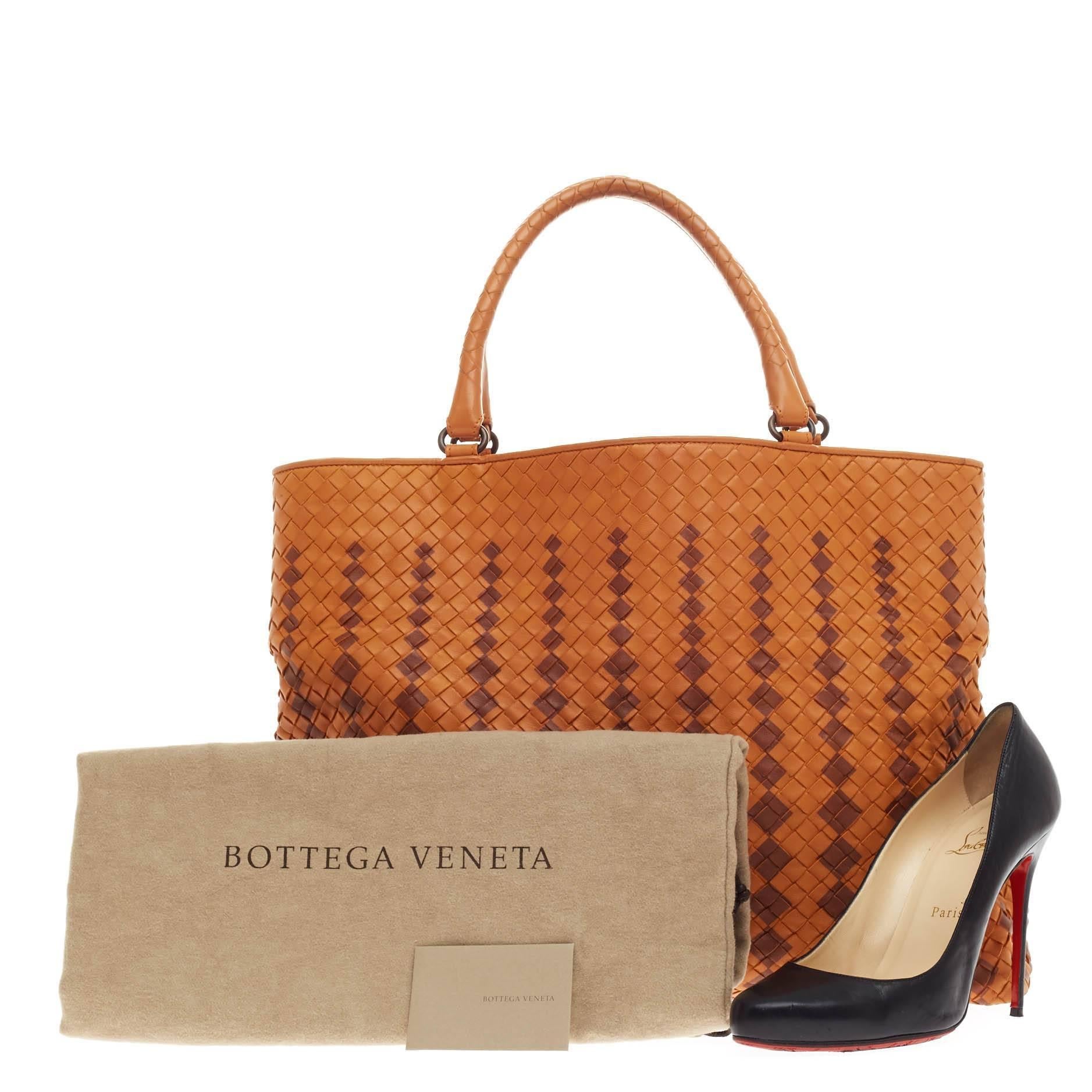This authentic Bottega Veneta Braided Open Tote Intrecciato Nappa Large presented in the brand's 20087 Collection is an oversized timelessly elegant tote with a casual silhouette. Constructed from orange nappa leather woven in Bottega Veneta's