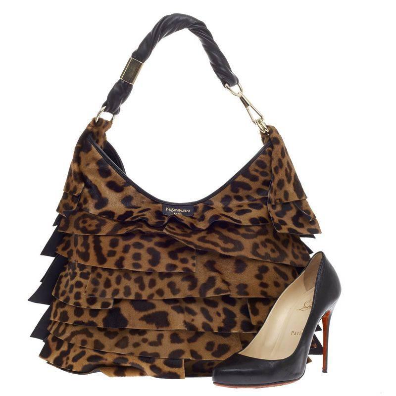 This authentic Saint Laurent St. Tropez Shoulder Bag Leopard Print Pony Hair Large is the ideal everyday chic bag. Crafted in layered leopard printed pony hair, this feminine and easy-to-carry shoulder bag features a looped single strap and