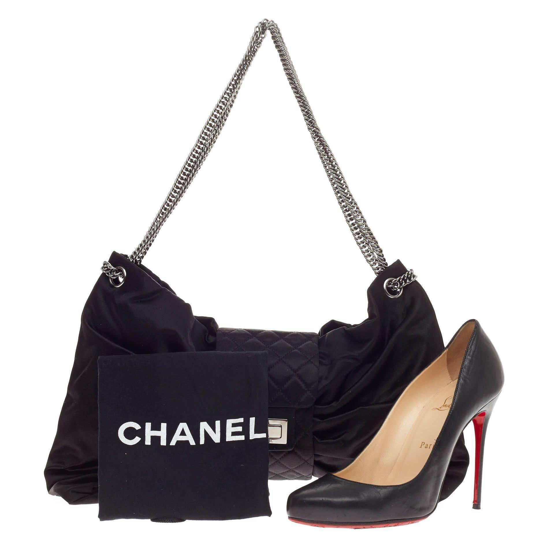 This authentic Chanel Bow Bag Satin Large presented in the brand's Spring/Summer 2008 Collection is  stylish and luxurious in design perfect for day to evening look. Crafted from soft black satin, this unique bow bag features Chanel's signature