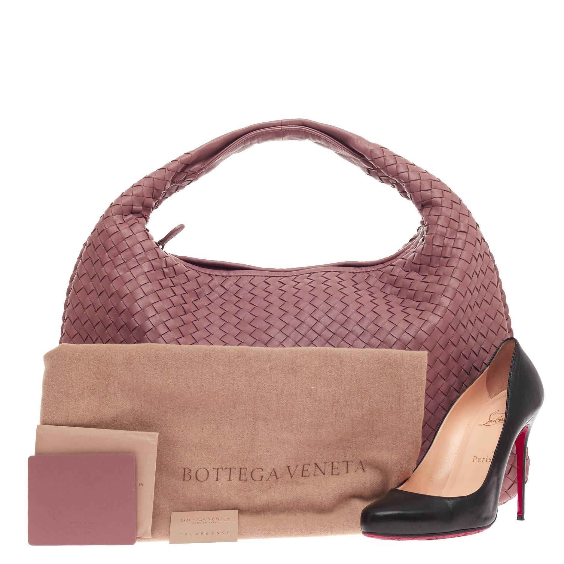 This authentic Bottega Veneta Veneta Hobo Intrecciato Nappa Large is a timelessly elegant bag with a casual silhouette. Crafted from pink mauve nappa leather woven in Bottega Veneta's signature intrecciato method, this versatile, highly-crafted hobo