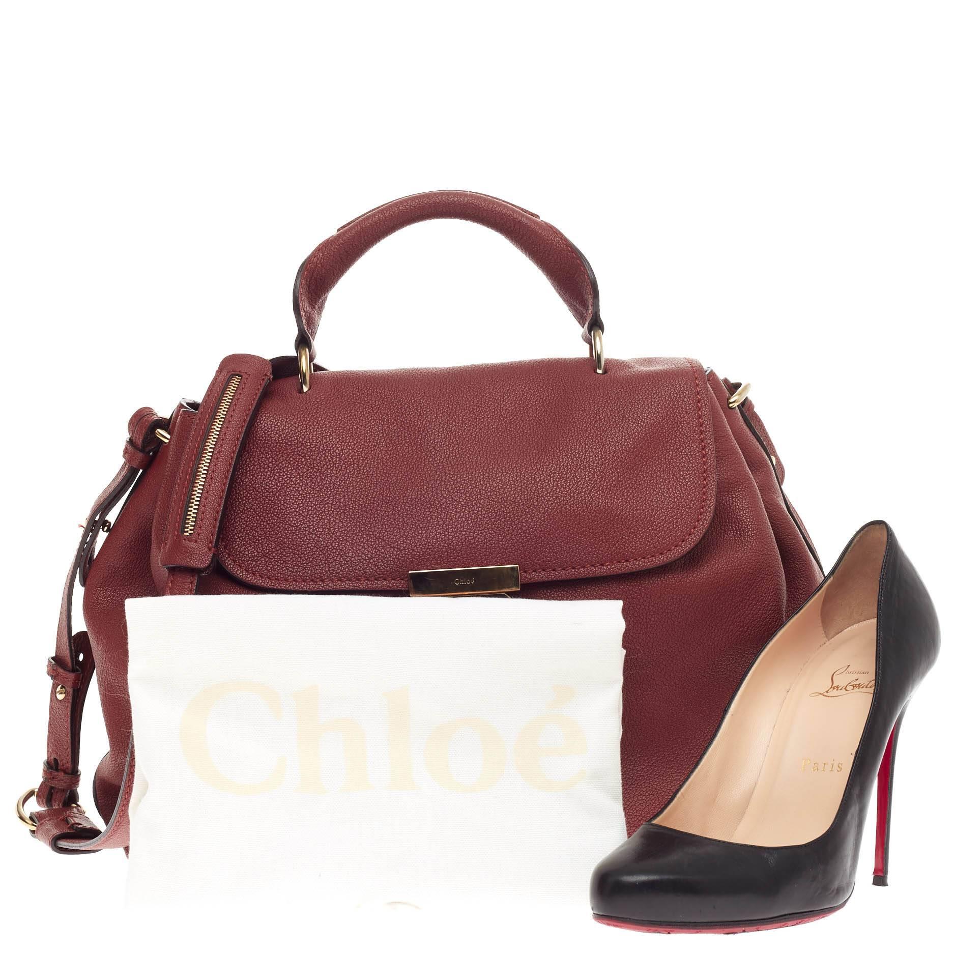 This authentic Chloe Elsie Convertible Satchel Leather Medium first introduced in the brand’s 2012 Spring collection mixes effortless style and easy functionality. Crafted from supple burgundy red leather, this satchel features a single rolled