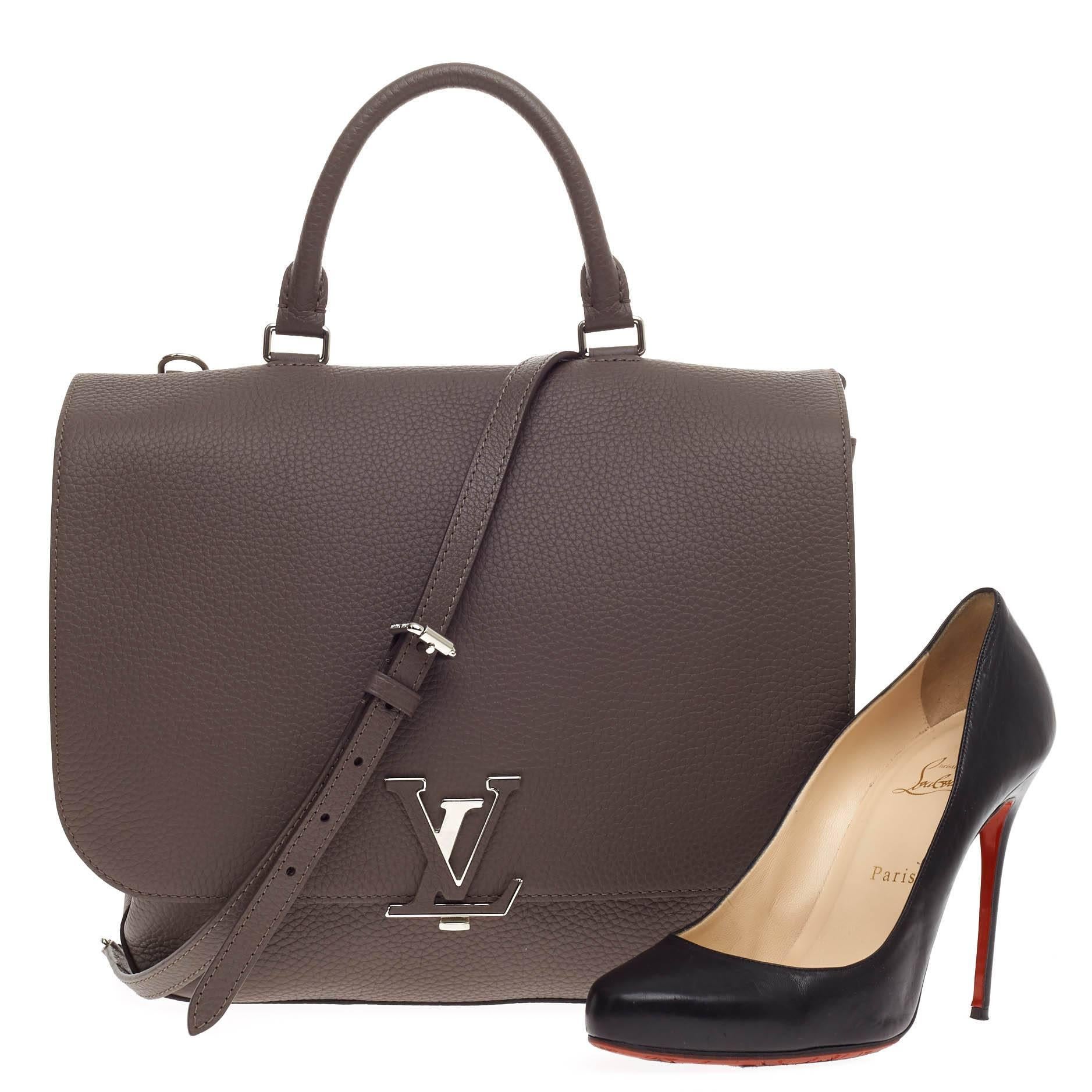 This authentic Louis Vuitton Volta Leather presented in the brand's Spring/Summer 2015 Collection updates its modern, minimalistic design following the popular Capucines line. Crafted from supple, grained khaki taurillon leather, this elegant