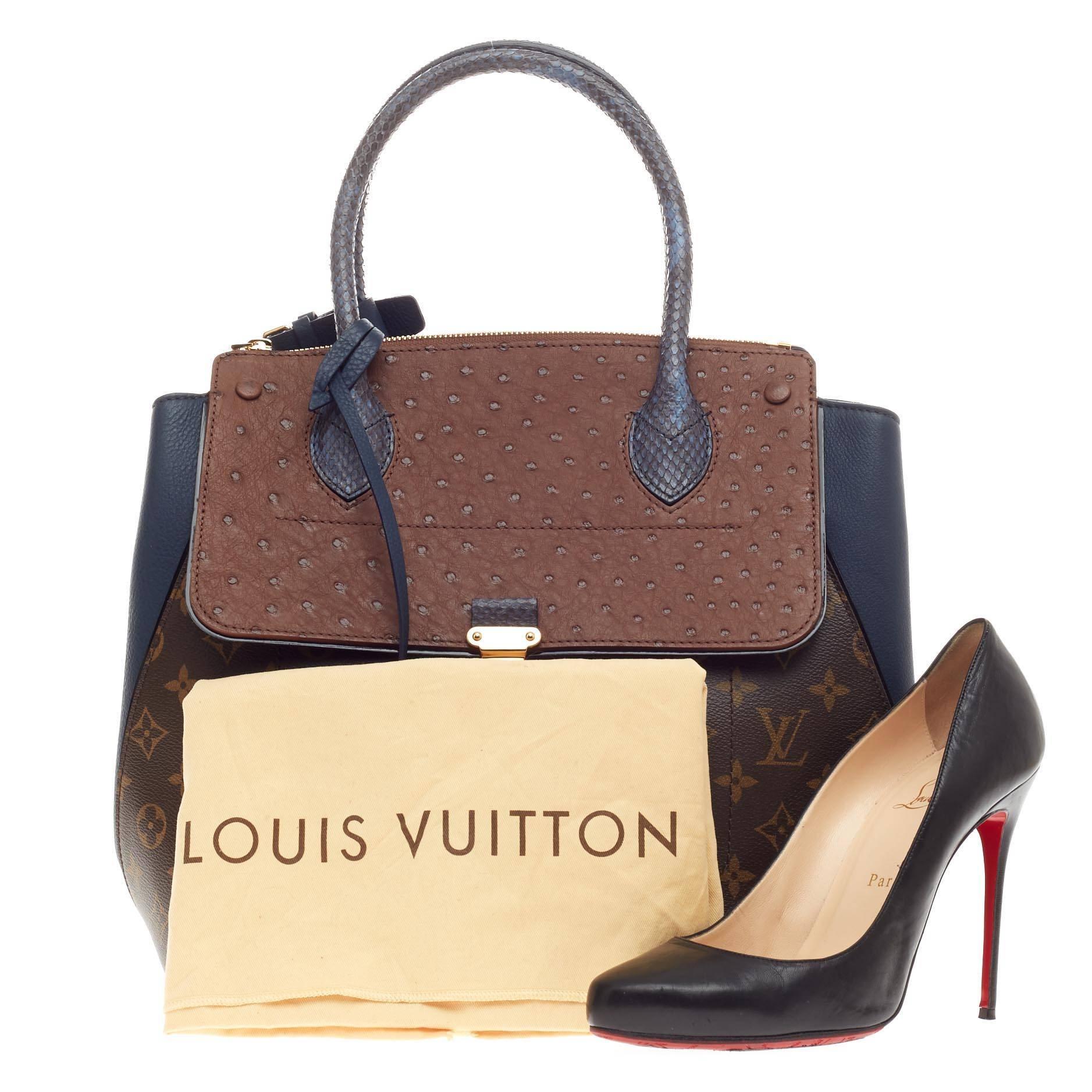 This authentic Louis Vuitton Majestueux Tote Monogram Canvas and Exotics MM presented in the brand's Fall/Winter 2012 Collection showcases an avant-garde design inspired by the brand's luxurious heritage. Crafted from the brand’s signature brown