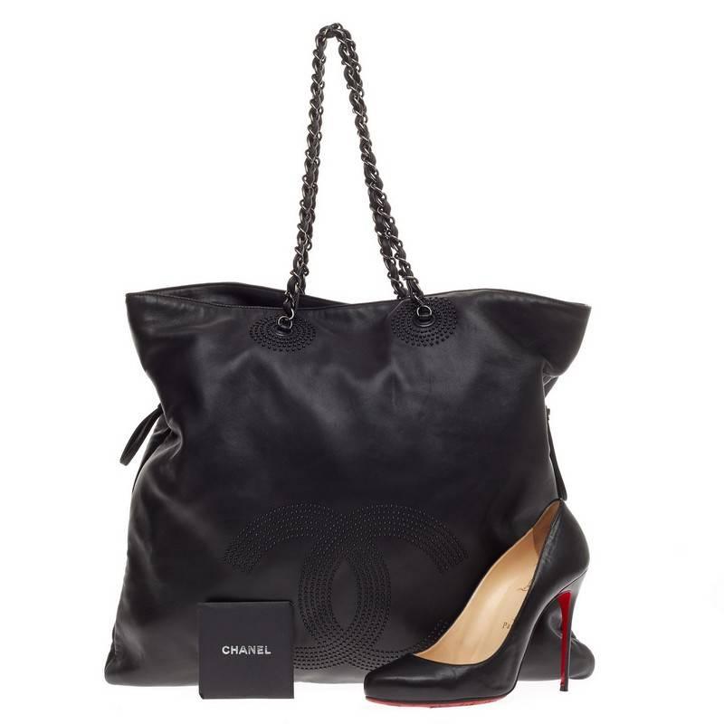This authentic Chanel Bon Bon Tote Studded Lambskin is a modern design with subtle edge made for everyday use. Crafted from supple black lambskin leather, this no-fuss, stylish tote features black mini studs in CC logo, woven-in leather chain