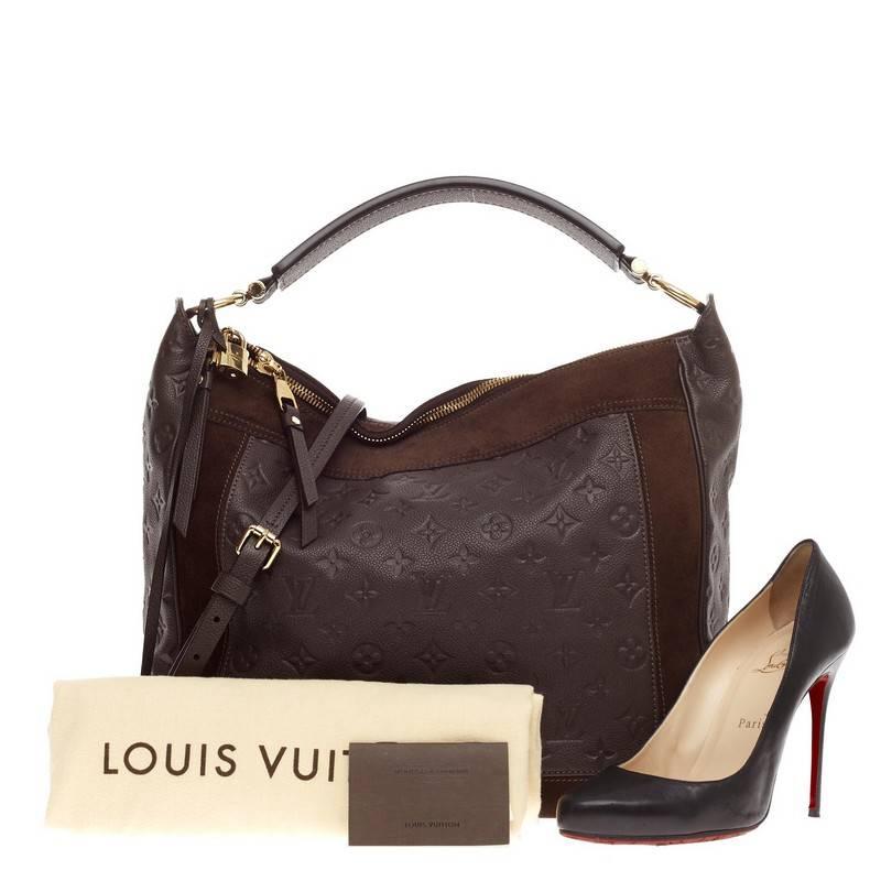 This authentic Louis Vuitton Audacieuse Monogram Empreinte Leather MM is a stylish and functional must-have for LV lovers. Crafted from a combination of ombre brown monogram empreinte leather and brown suede, this glamorous hobo features a flat tall