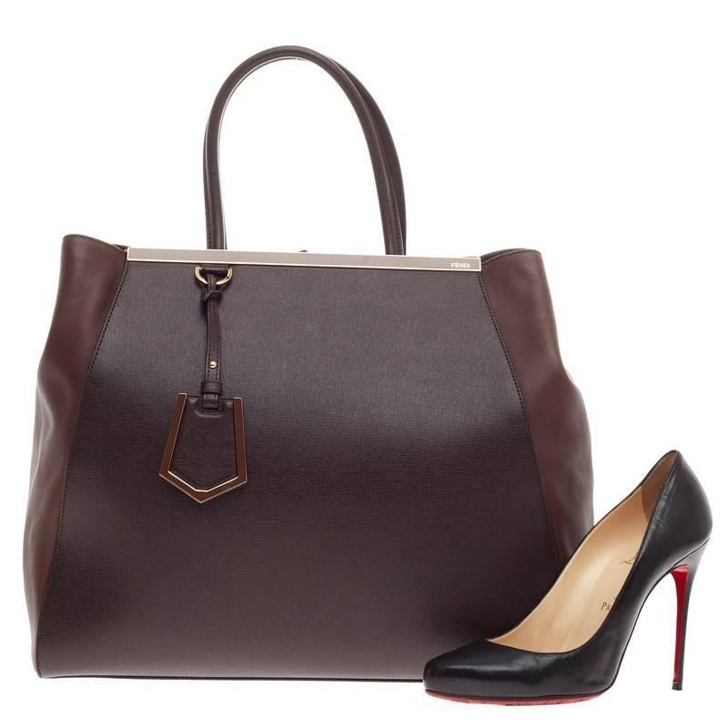 This authentic Fendi 2Jours Leather Large is impeccably stylish with its rich brown hue, simple silhouette and structured design. Finely crafted in sturdy cross-grain leather with soft calfskin sides, this popular tote features a shining top bar