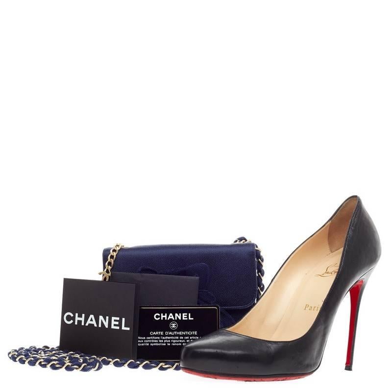 This authentic Chanel Rosette Flap Bag Satin and Mesh Mini is perfect for any formal event or night outs. Crafted in navy satin, this mini evening bag features a mesh floral applique, woven-in mesh straps threaded through a gold chain with Chanel