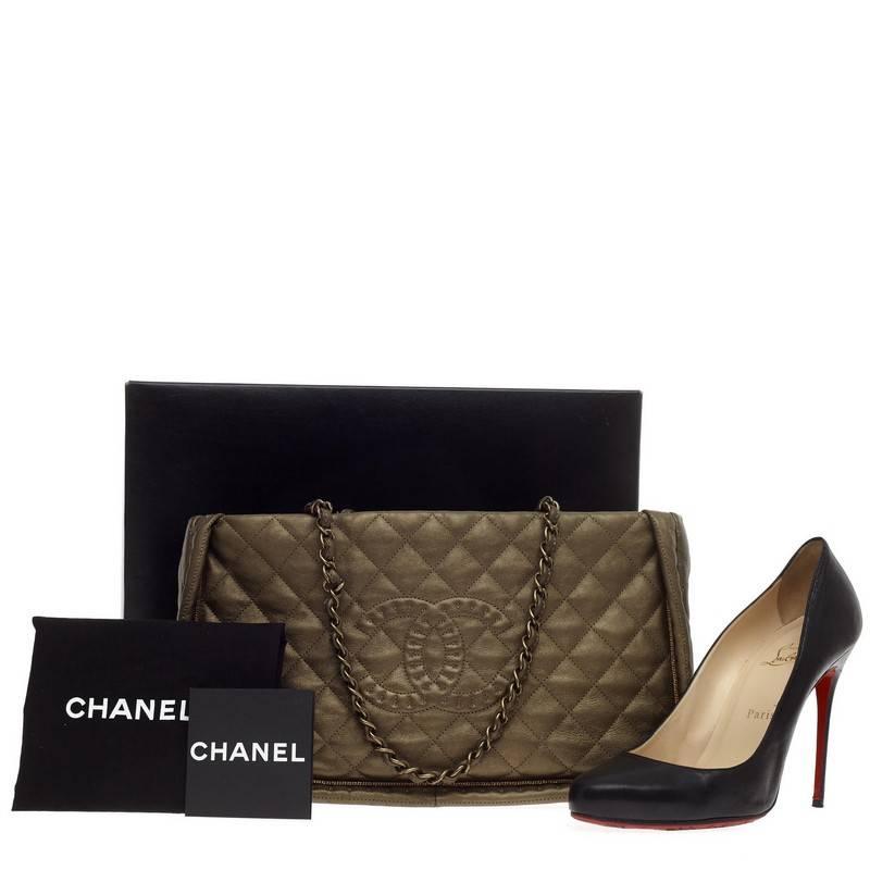 This authentic Chanel Istanbul Tote Quilted Leather Small presented during the brand's 2011 Fall collection mixes classic Chanel styling with a modern twist. Crafted from dark gold diamond quilted leather, this chic tote features an all around