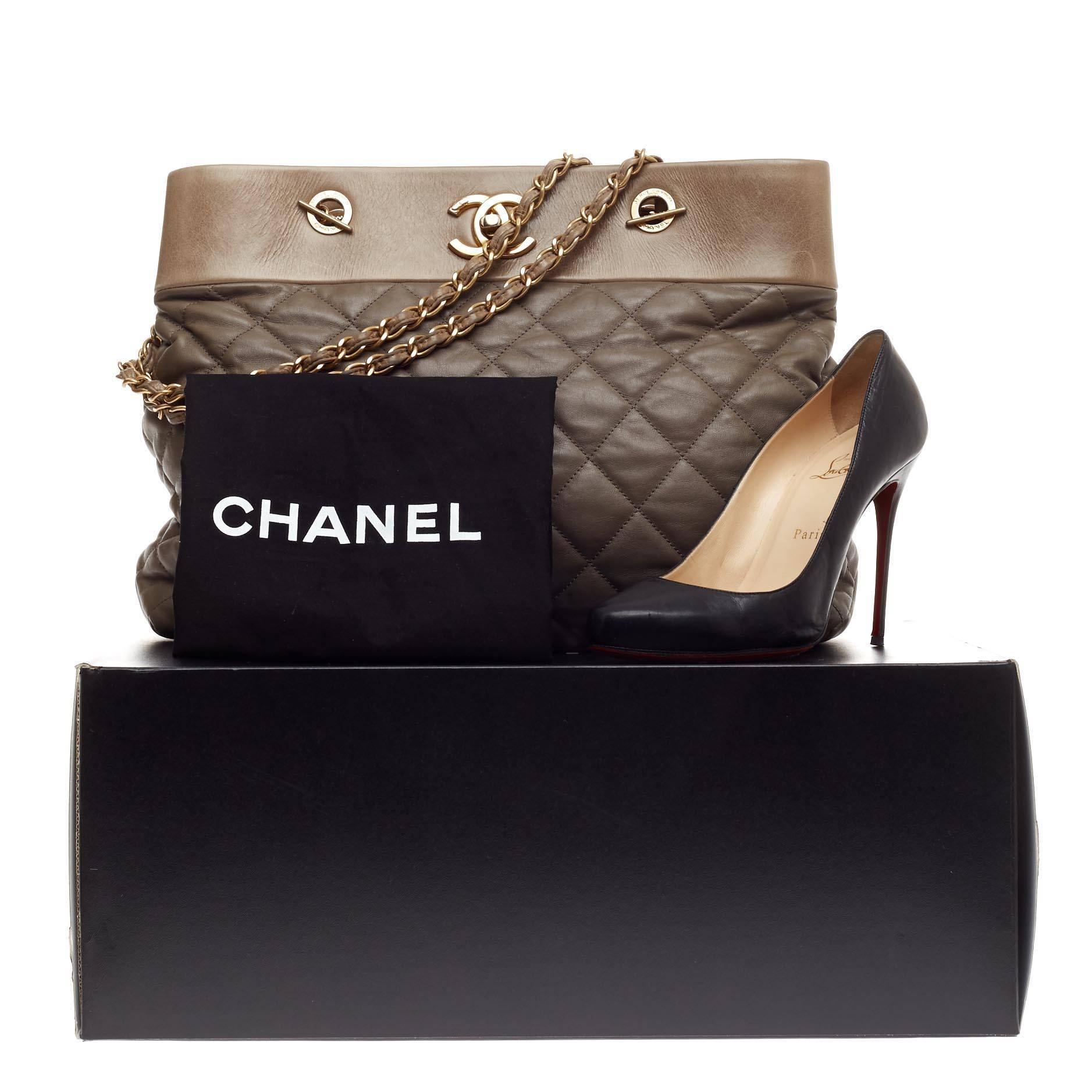 This authentic Chanel Soft Elegance Tote Distressed Calfskin Large presented in the brand's Fall/Winter 2013 Collection mixes classic Chanel styling with a modern twist. Crafted from distressed quilted calfskin in neutral khaki gray, this beautiful