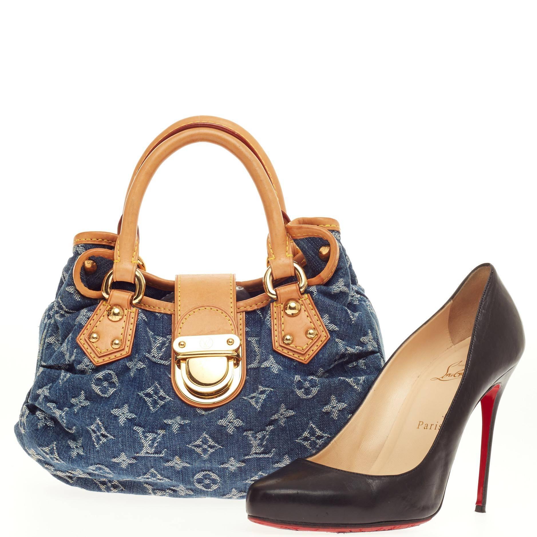 This authentic Louis Vuitton Pleaty Denim Mini showcases a fun twist to the classic monogram design. Crafted from stonewashed blue monogram denim, this small hobo features dual-rolled vachetta leather handles, vachetta leather trims with yellow