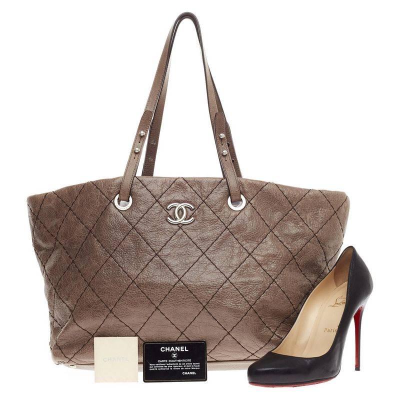 This authentic Chanel On the Road Tote Quilted Leather Small showcases the brand's classic style with everyday functionality perfect for the modern woman. Crafted from brown diamond quilted soft leather, this tote features dual flat brown leather