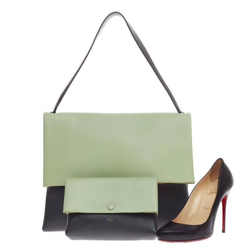 This authentic Celine All Soft Tote Leather designed in mint green and dark gray calfskin leather with beige suede underneath its flap. It displays a neutral and understated look perfect for the modern woman. This no-fuss tote features a single