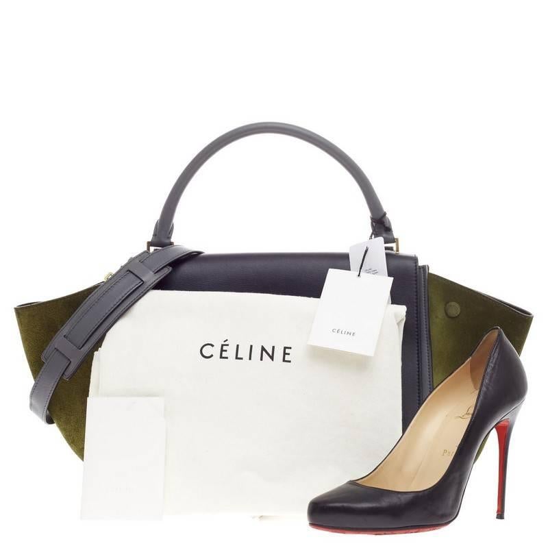 This authentic Celine Trapeze Tricolor Leather Medium presented in the brand's 2013 Collection is a modern classic, featuring a cool palette of navy blue and blue gray leather body with a striking olive suede wings. With its subdued color palette,