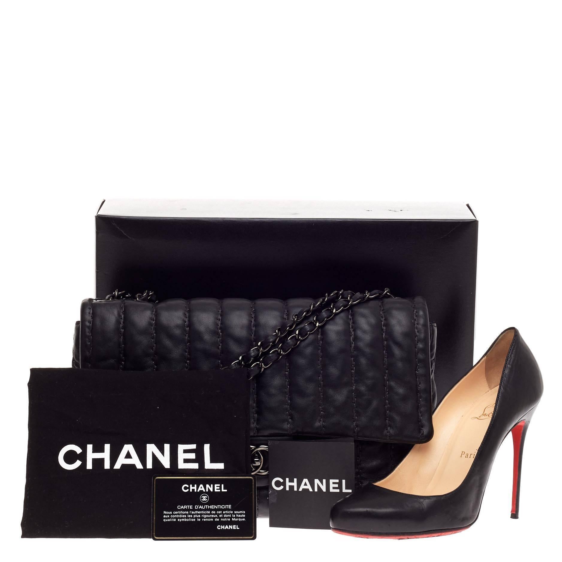 This authentic Chanel Vertical Stitch Single Flap Lambskin Jumbo is a must-have for all fashion lovers. Crafted from lambskin leather, this modern-style, edgy flap features vertical quilted stitching, dual woven-in leather chain strap, exterior back