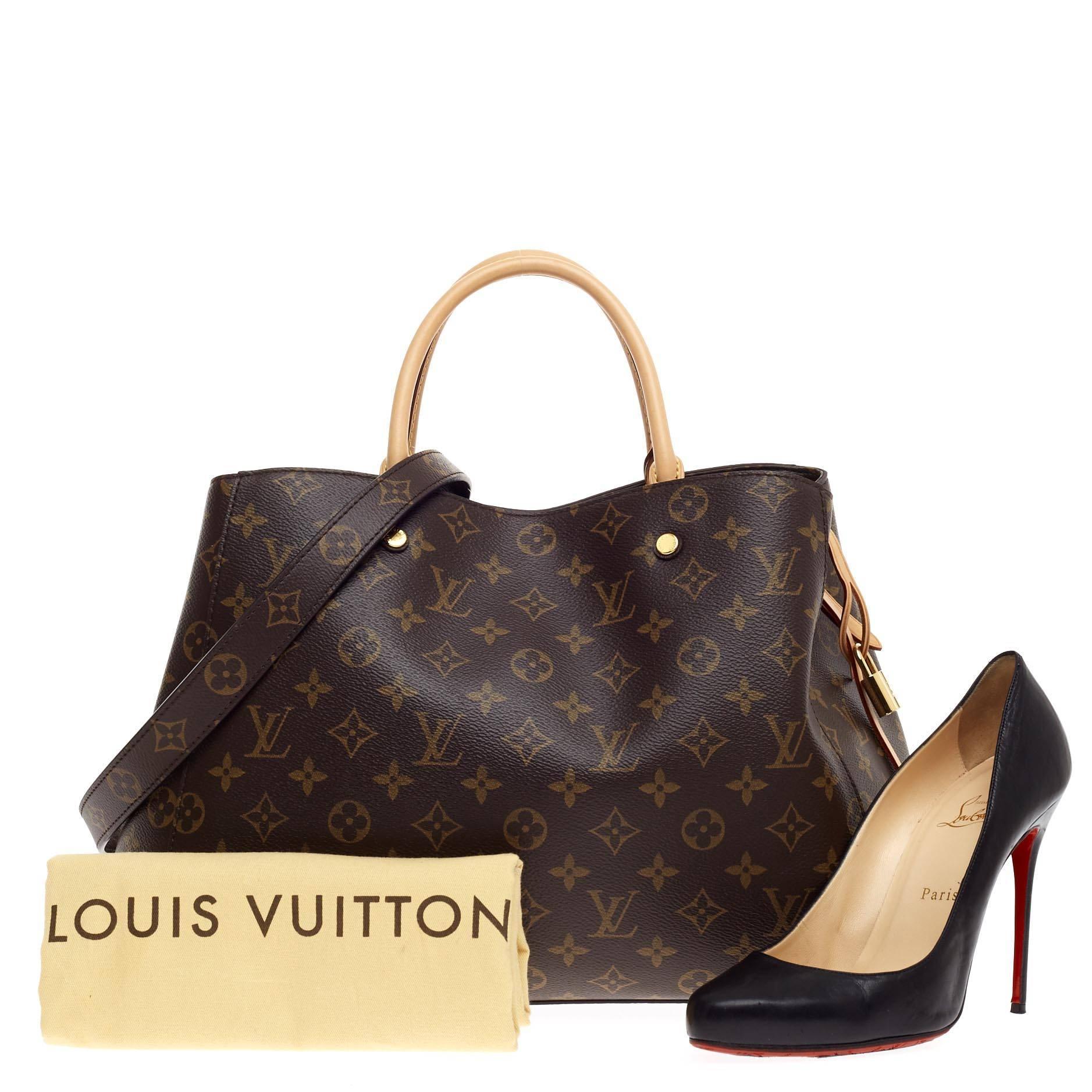 This authentic Louis Vuitton Montaigne Monogram Canvas GM named after the famed Parisian location is as sophisticated as it is sturdy. Crafted from the iconic Louis Vuitton's brown monogram printed canvas, this tote features dual-rolled vachetta