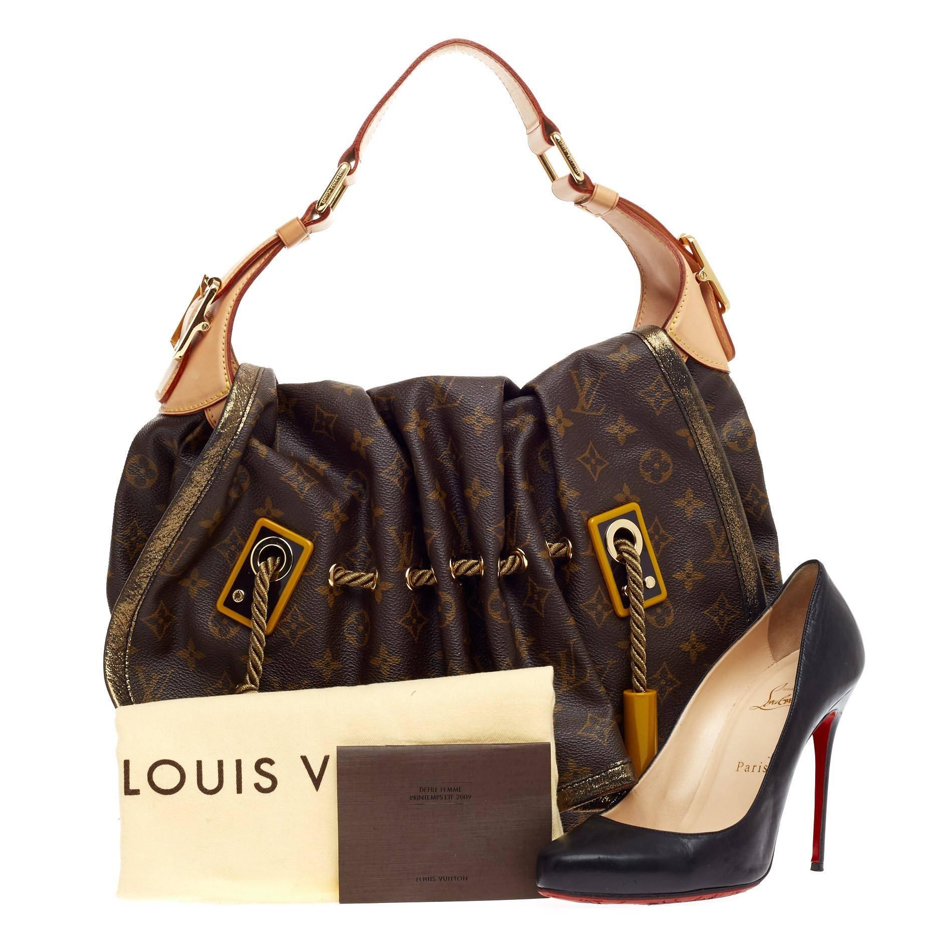 This authentic Louis Vuitton Kalahari Monogram Canvas GM presented in the brand's Spring/Summer 2009 Collection aptly named after the beautiful sub-saharan african desert mixes traditional styling with luxurious ethnic motif. Crafted in iconic