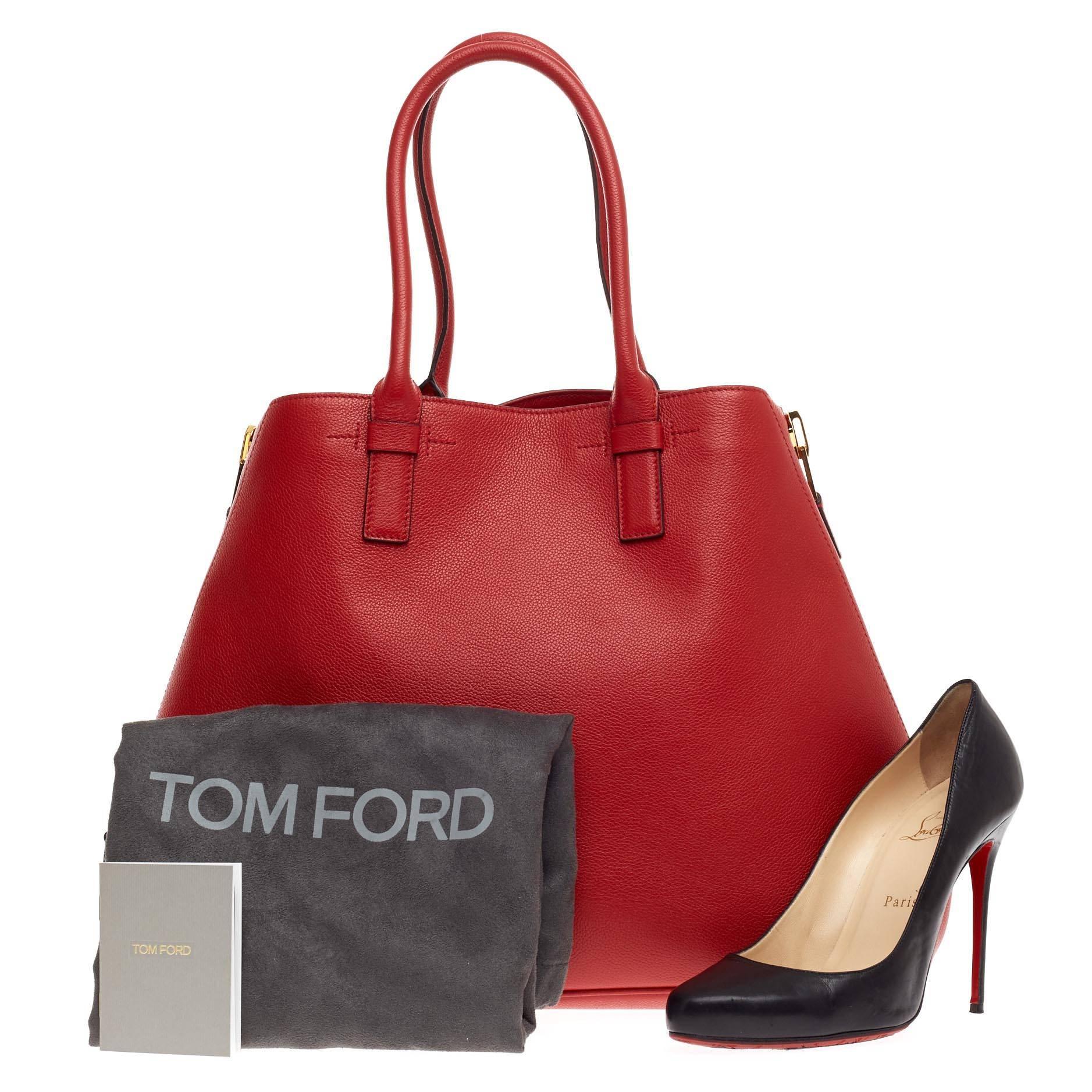 This authentic Tom Ford Jennifer Zip Tote Leather Large redefines modern luxury with timeless elegance. Crafted from vivid classic red leather, this tote features dual-rolled tall handles, zipped side gussets for expansion, protective base studs,