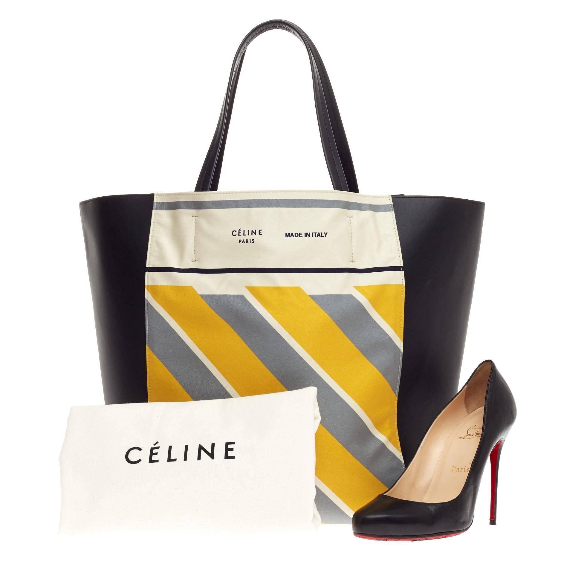 This authentic Celine Foulard Phantom Cabas Tote Leather presented in the brand's Fall 2013 Collection is the perfect everyday shopper bag holding all essentials. Crafted from white foulard fabric with diagonal yellow and gray stripes and black