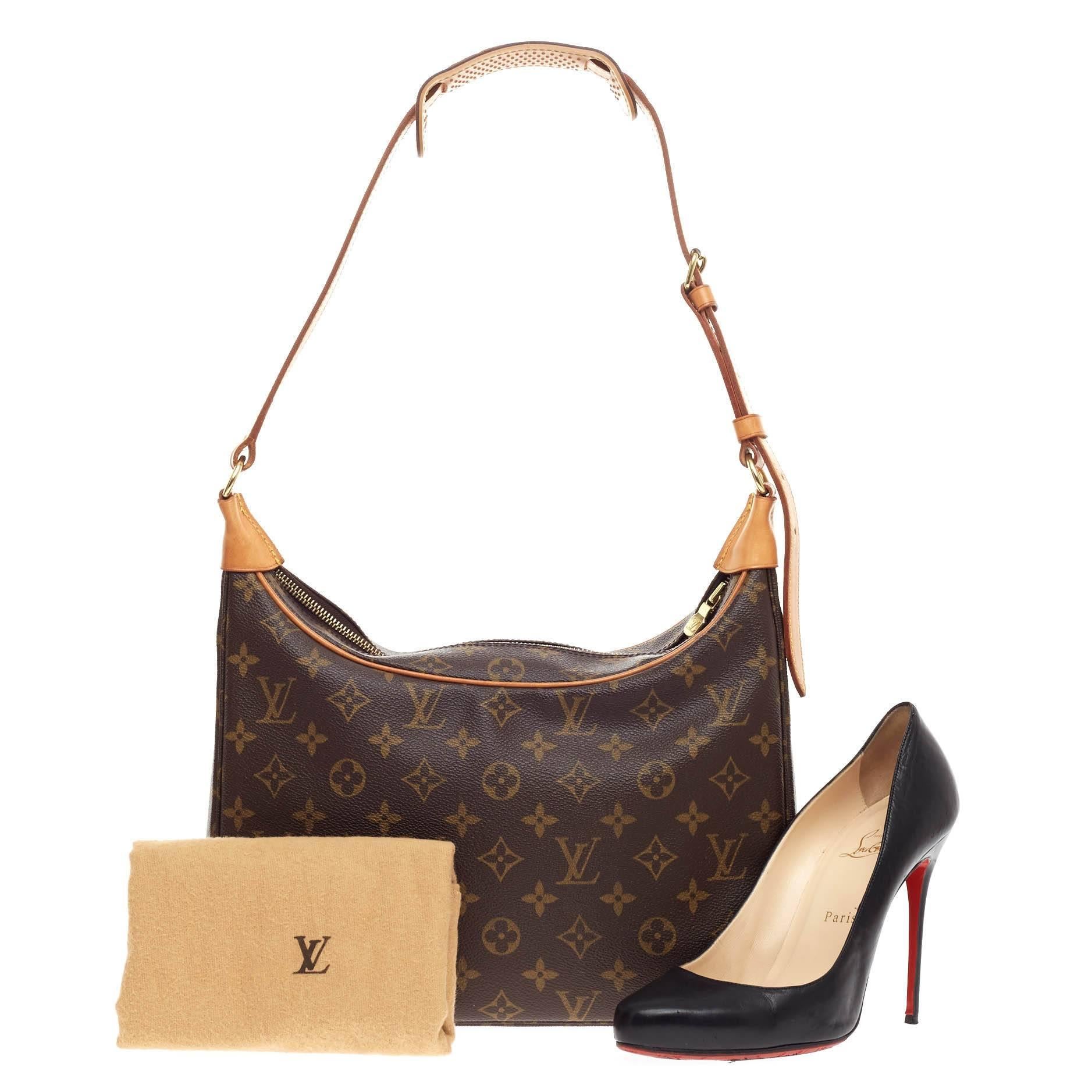 This authentic Louis Vuitton Boulogne Monogram Canvas 30 showcases a stylish design perfect for everyday use. Crafted from brown monogram printed canvas, this satchel features an adjustable vachetta leather strap, vachetta leather trims, and