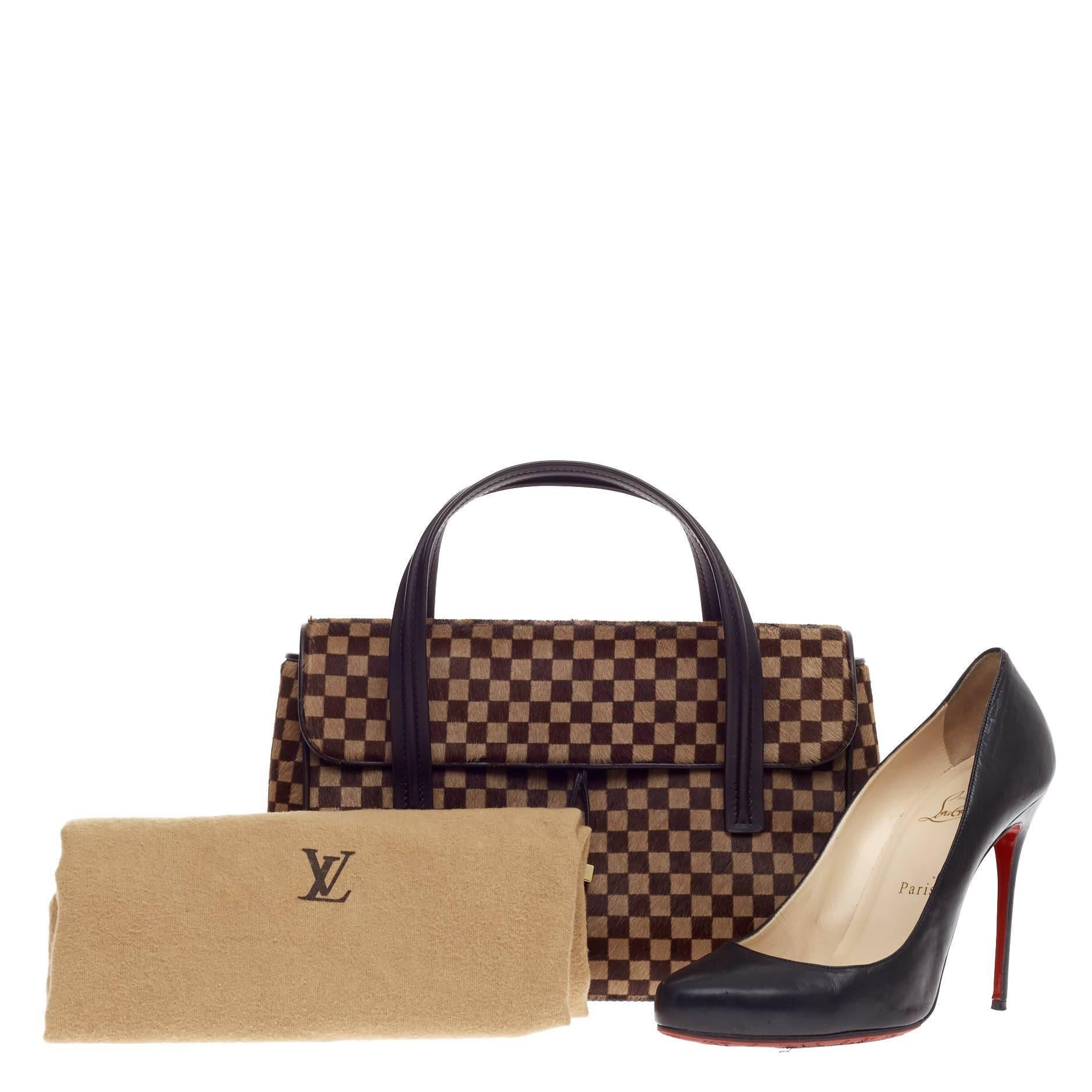 This authentic Lionne Damier Sauvage is a unique and exquisite piece for a Louis Vuitton bag lover. Crafted in dark brown damier calf hair, this lovely bag features smooth dark brown leather trims, dual flat leather top handles, rear flat pocket,