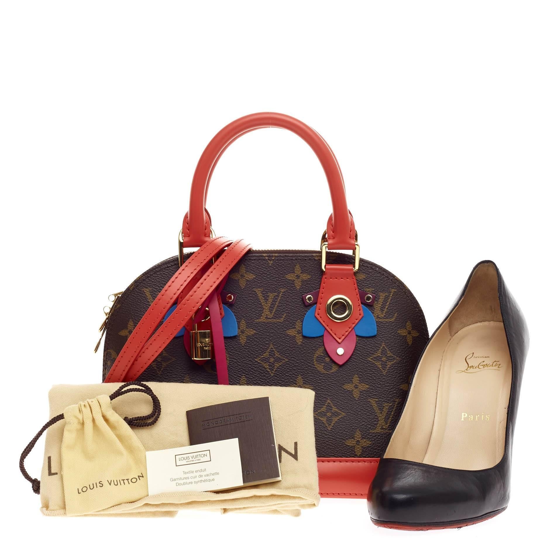 This authentic Louis Vuitton Alma Limited Edition Totem Monogram Canvas BB presented in the brand's Fall/Winter 2015 Collection updates its classic Alma with playful styling and inspired by Gaston Vuitton's african tribal masks. Crafted in iconic