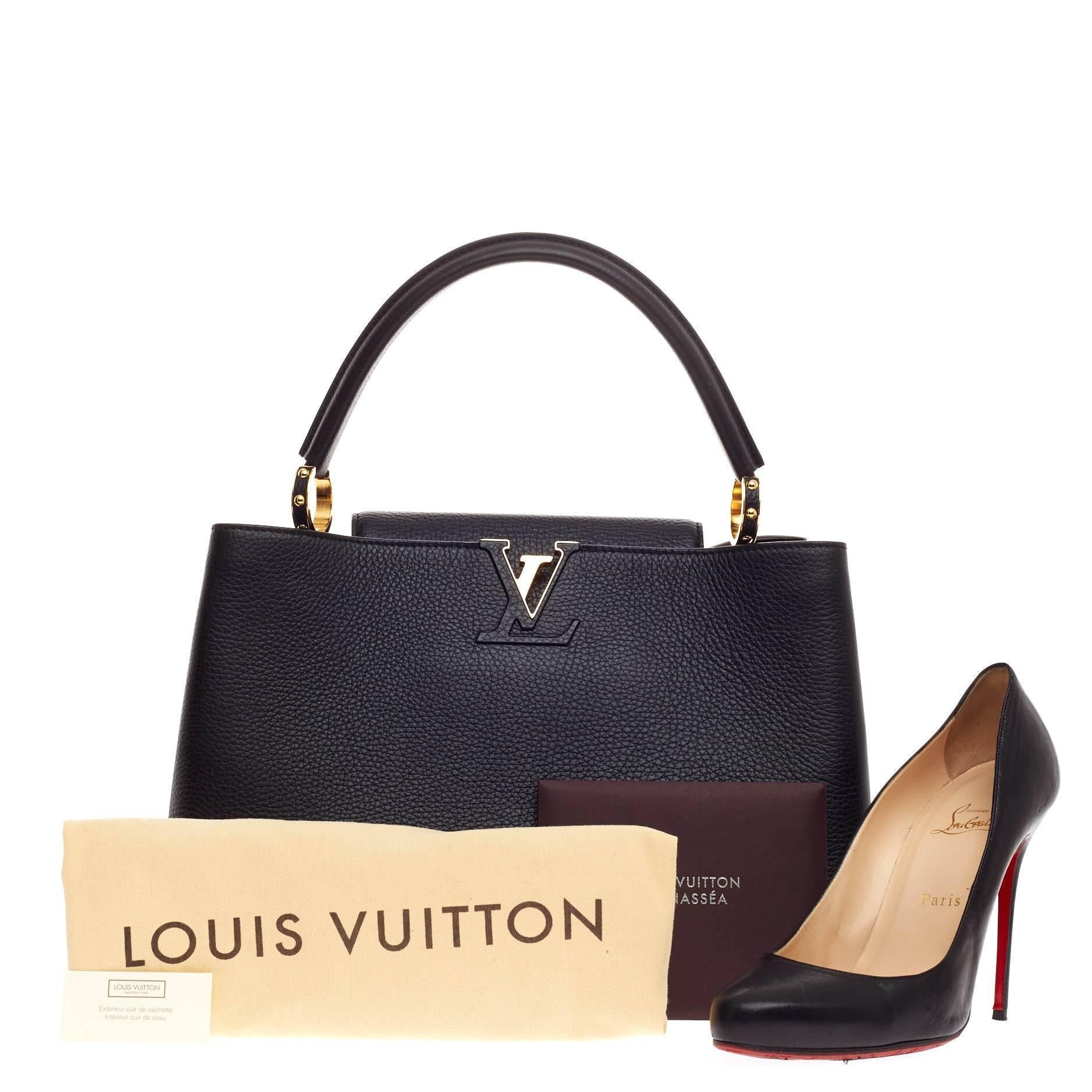 This authentic Louis Vuitton Capucines Leather MM is sophisticated and ladylike luxurious bag from the brand's Fall 2013 Collection inspired by its Parisian heritage. Crafted in nior black taurillon leather, this chic, stand-out bag features a