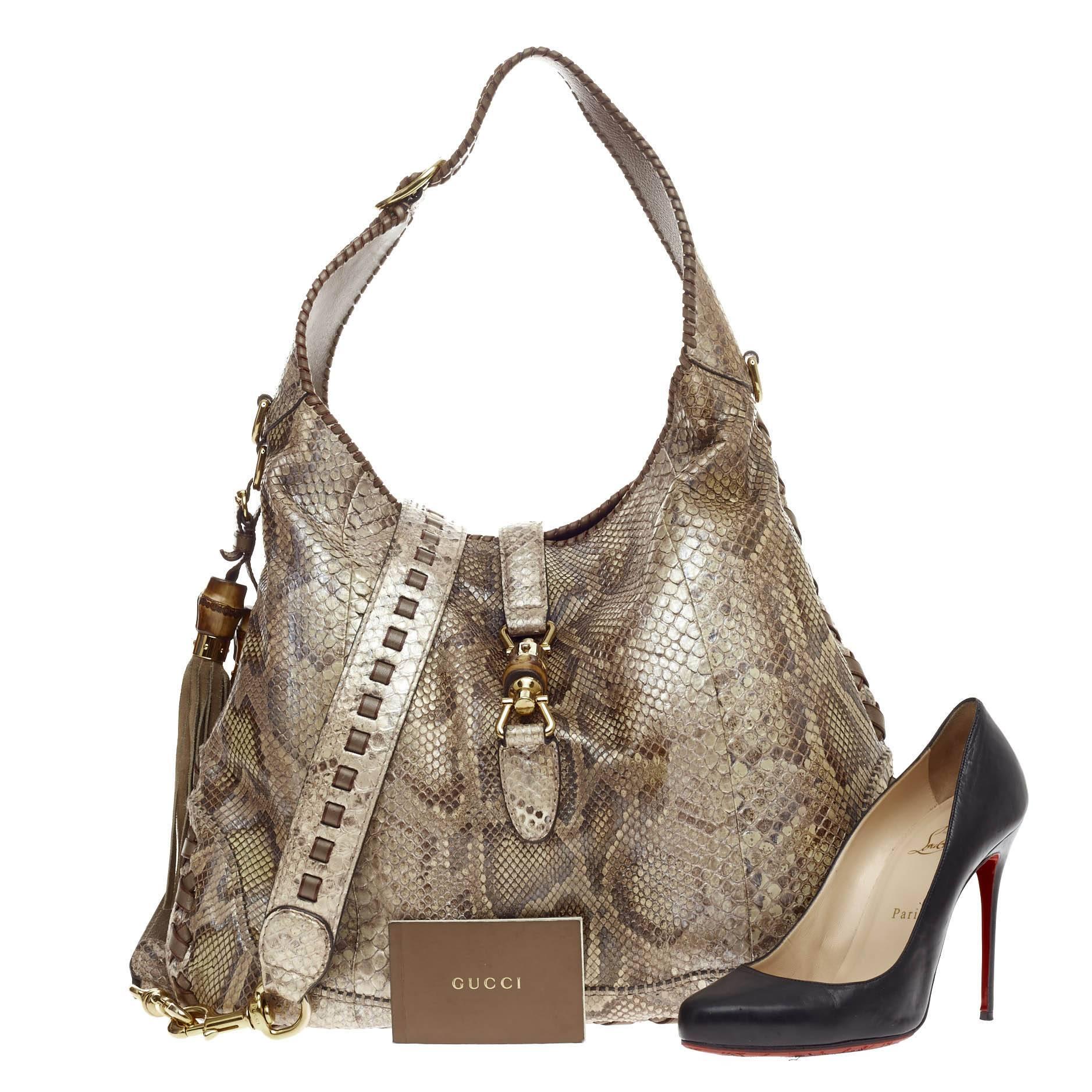 This authentic Gucci New Jackie Python Large is a must-have luxurious everyday hobo fit for the modern woman. Constructed from genuine multicolor beige and brown python skin, this bag features side fringe tassels with bamboo accents, cross leather