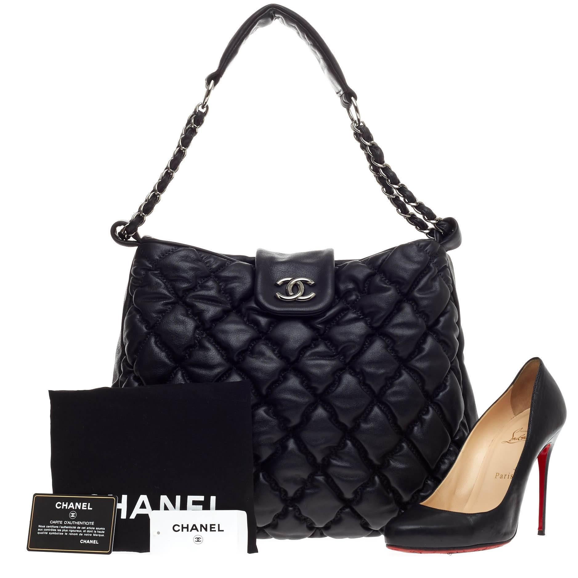 This authentic Chanel Bubble Hobo Quilted lambskin Large is sure to compliment just about every casual outfit. Crafted from classic black lambskin leather in modern bubble quilting, this soft, puffy bag features woven-in leather chain straps with