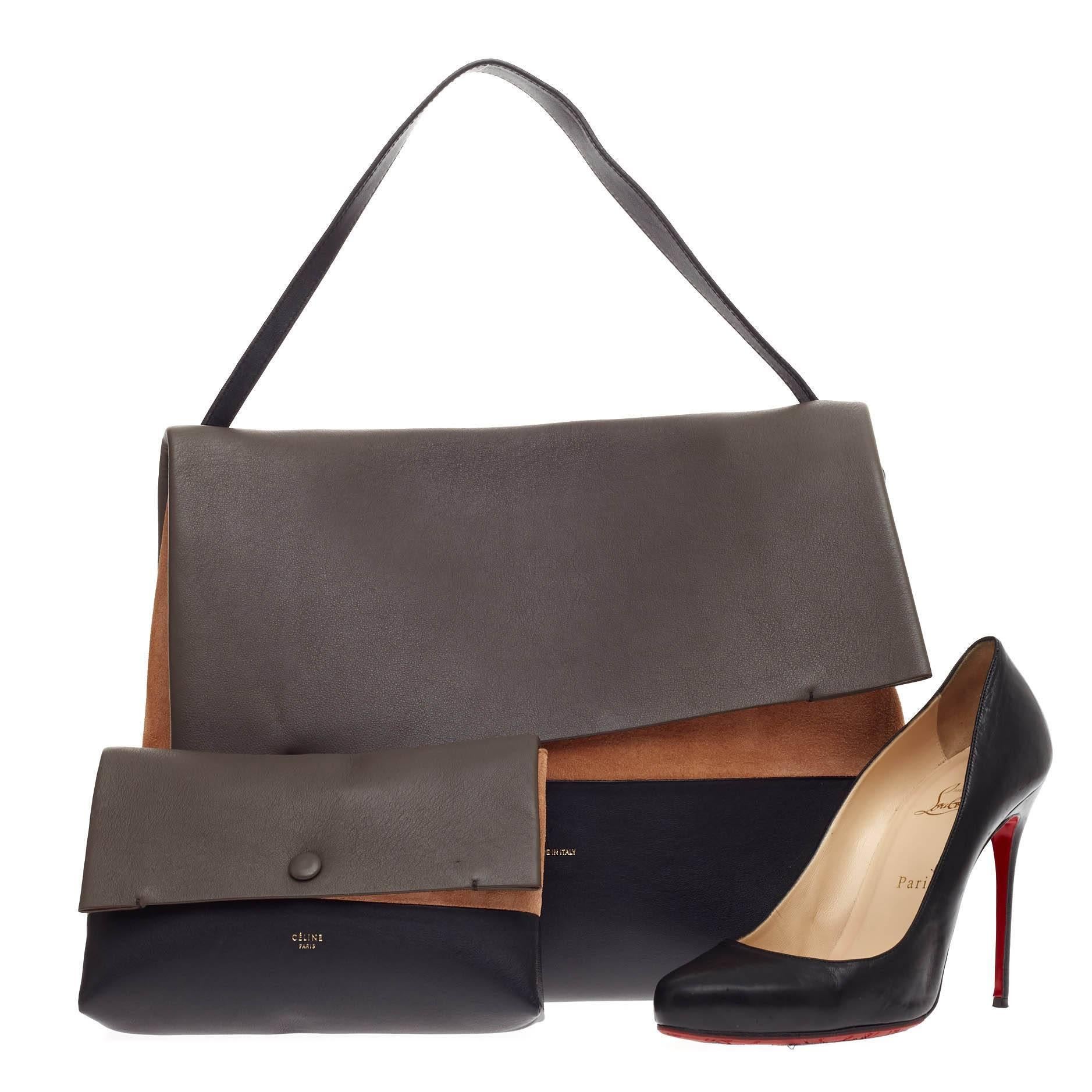 This authentic Celine All Soft Tote Leather is a neutral and understated look perfect for the modern woman. Crafted from triad neutral shades of gray leather, navy blue leather and tan suede, this minimalist tote features a single leather shoulder