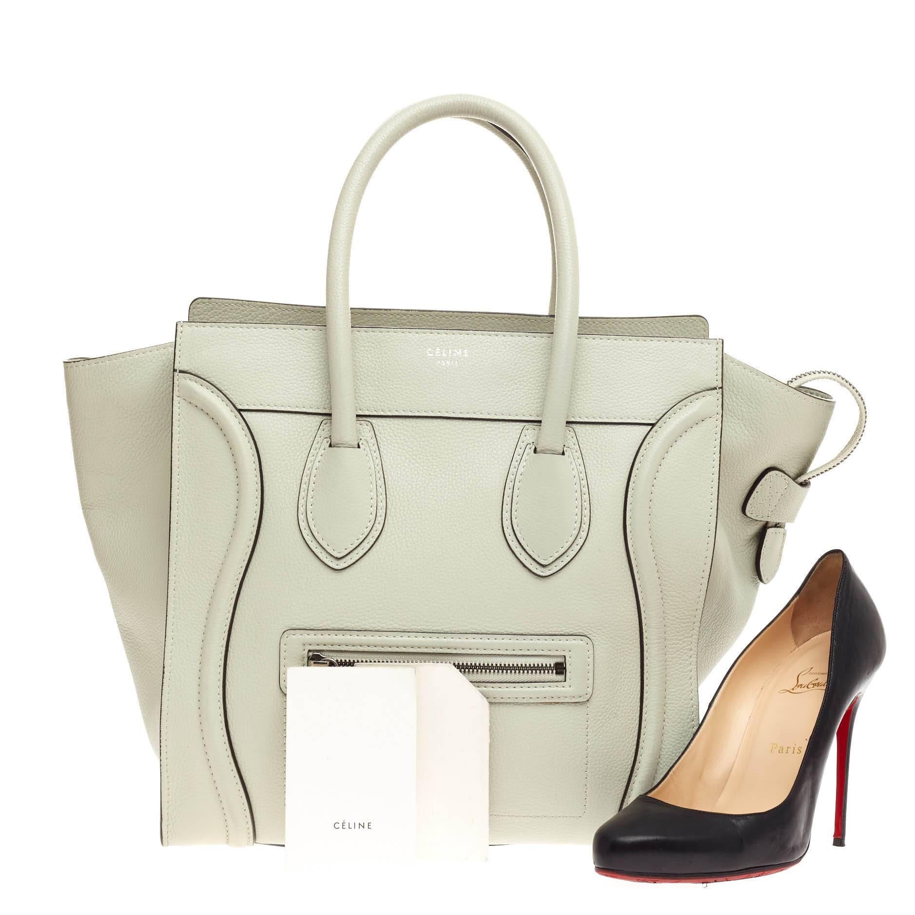 This authentic Celine Luggage Grainy Leather Mini epitomizes Phoebe Philo's minimalist yet chic style. Constructed in pale sea foam green grainy leather, this beloved fashionista's bag features dual-rolled leather handles, a frontal zip pocket,