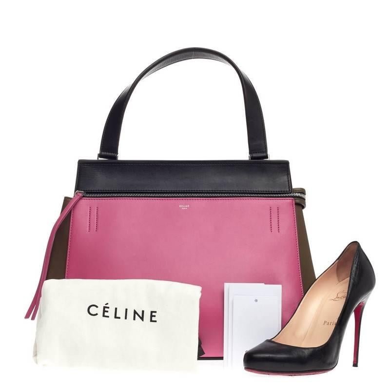 This authentic Celine Edge Bag Leather Medium is striking in its simplicity and structure. Constructed from hot pink, olive green, and black leather, this boxy satchel features single looped shoulder strap, exterior back slip pocket with snap