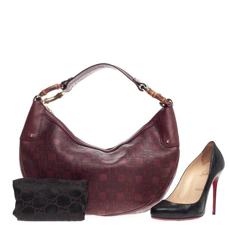 This authentic Gucci Bamboo Ring Half Moon Hobo Horsebit Embossed Leather is an iconic design that adds a touch of glamour to your casual look. Crafted from burgundy horsebit embossed leather, this hobo features a looping leather shoulder strap,