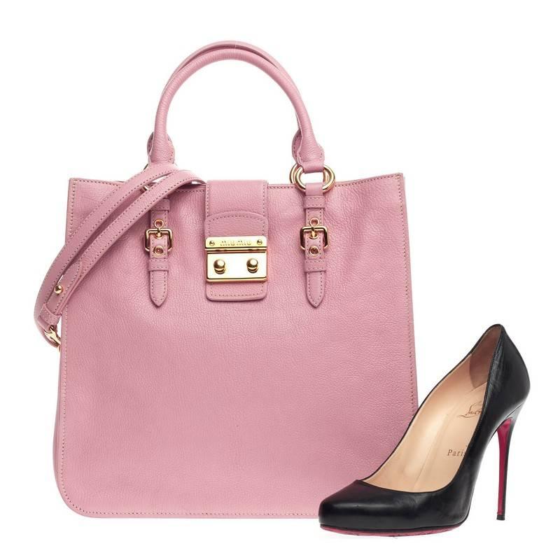 This authentic Miu Miu Madras Convertible Lock Tote Leather Medium showcases a chic and stylish design perfect for everyday use. Crafted from beautiful baby pink madras leather, this sophisticated tote features dual-rolled handles with belted