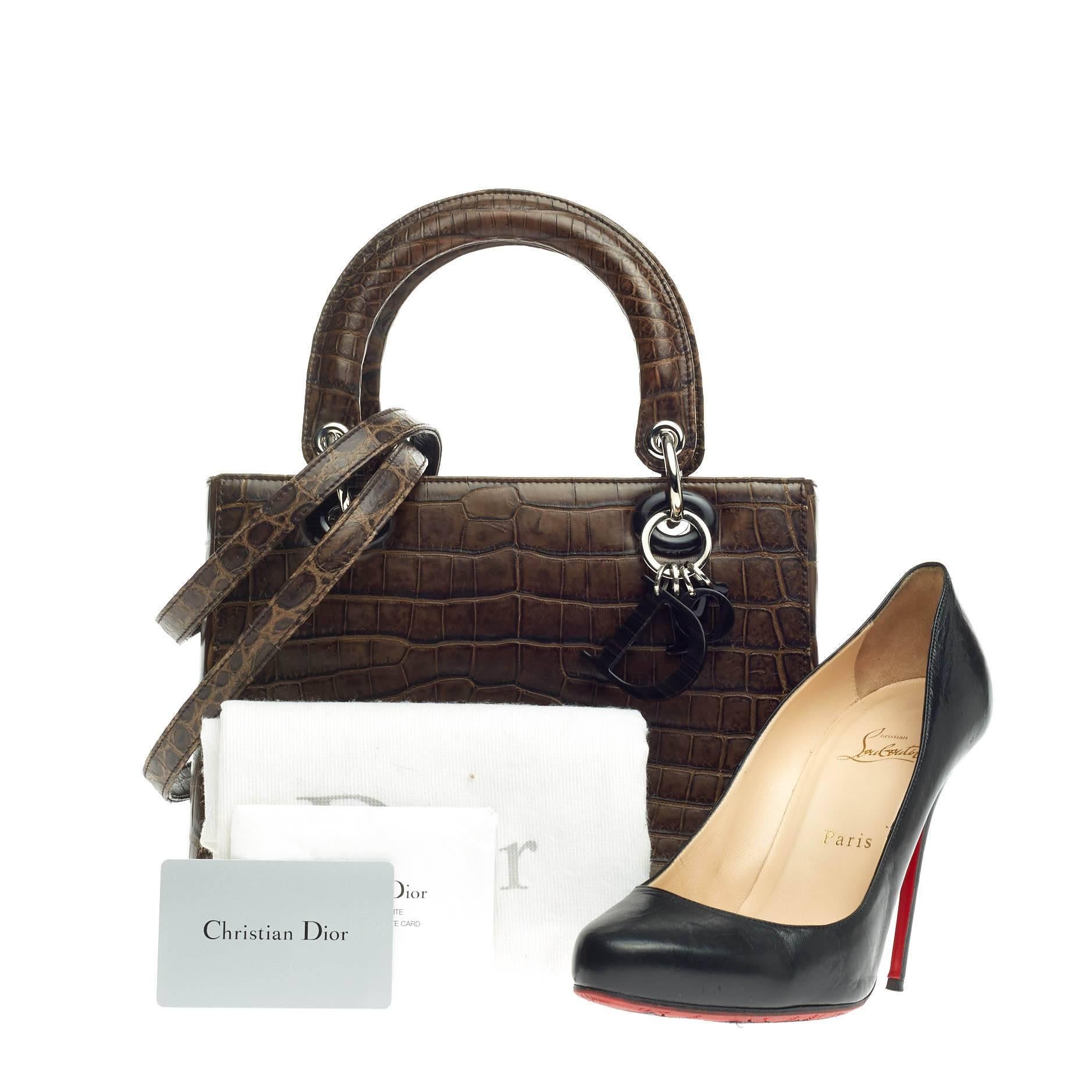 This authentic Christian Dior Lady Dior Crocodile Medium presented in the brand's Fall/Winter 2012 Collection is a coveted bag made for avid Dior fashionistas. Crafted from genuine brown crocodile skin, this luxurious, timeless bag features dual