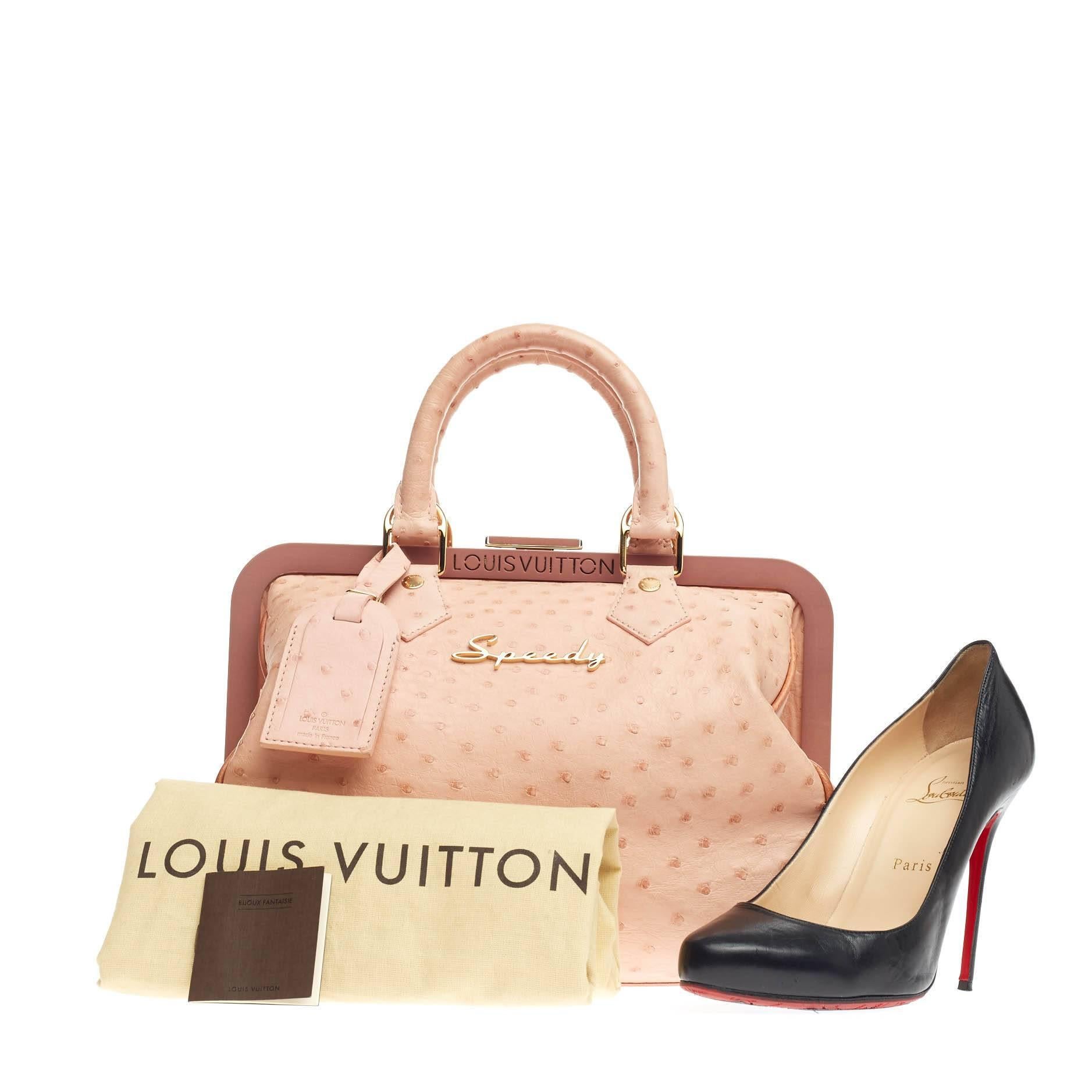This authentic Louis Vuitton Frame Speedy Ostrich is an ultra-rare piece first seen on the runway of Marc Jacob's Spring/Summer 2008 Collection. Crafted from poudre pink genuine ostrich skin, this limited edition feminine piece features dual-rolled