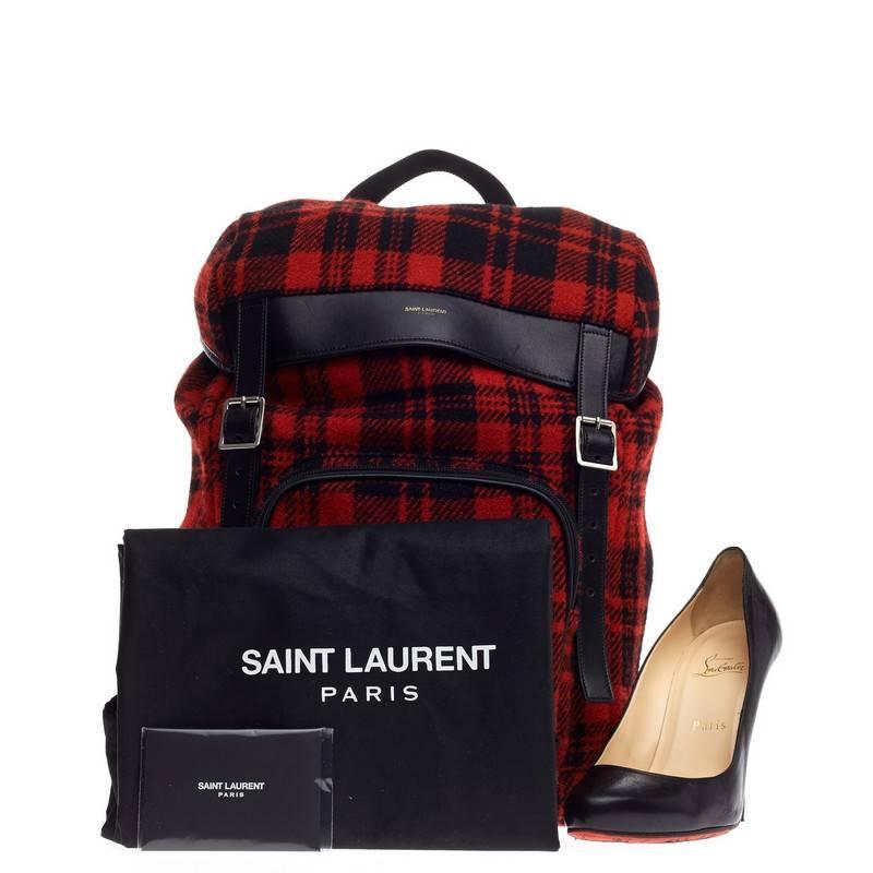 This authentic Saint Laurent Hunting Backpack Wool is a luxe backpack combining style and comfort. Crafted from stand-out red and black tartan plaid wool with black leather trims, this runway-ready backpack features dual flat adjustable backpack