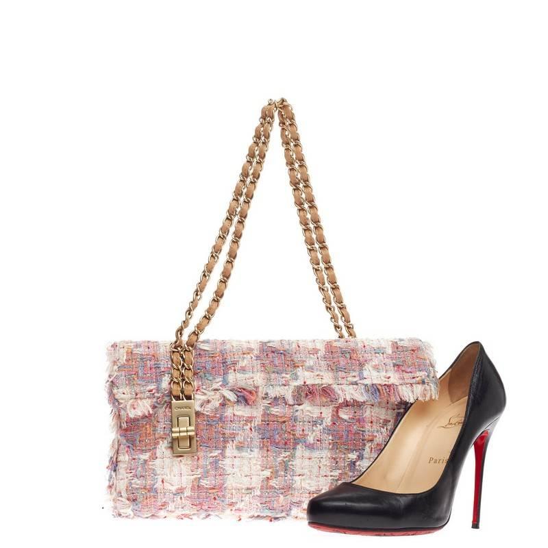 This authentic Chanel Vertical Lock Flap Bag Tweed Medium is a beautiful piece to hold for a night out or to add style to a daily casual outfit. Constructed in multicolor woven boucle tweed, this checkered flap features dual woven-in leather chain