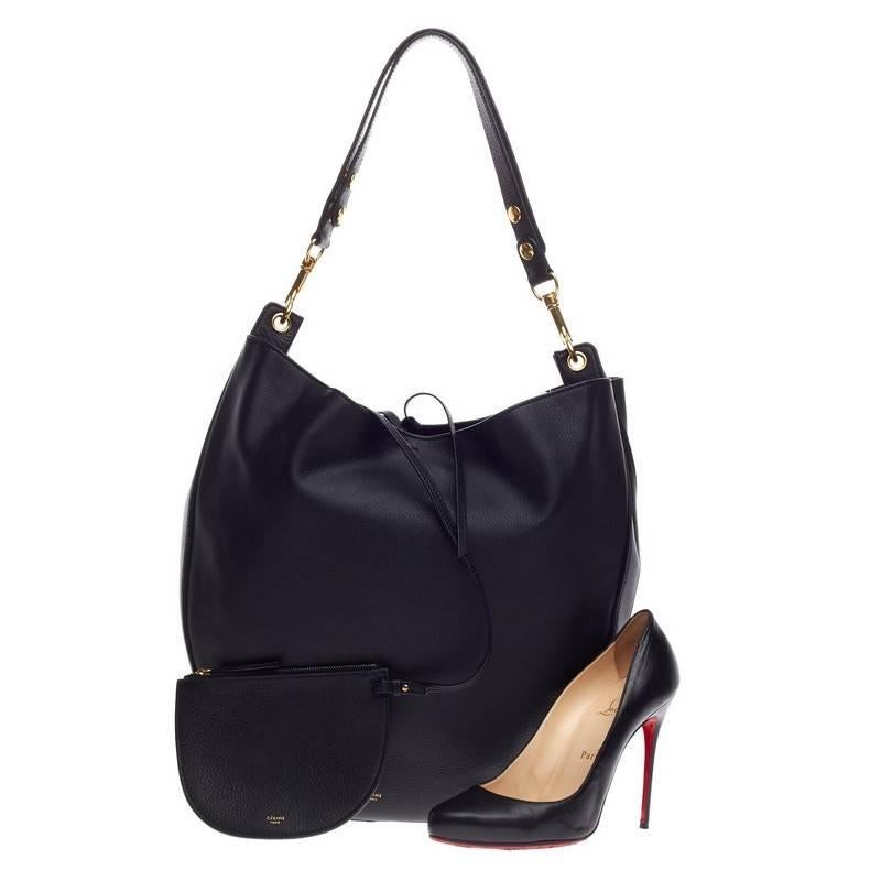 This authentic Celine Hobo Leather Large presented in the brand's Spring/Summer 2015 Collection mixes simple style with luxurious craftsmanship. Crafted from supple, sleek black palmelato calfskin leather, this modern hobo features a single,