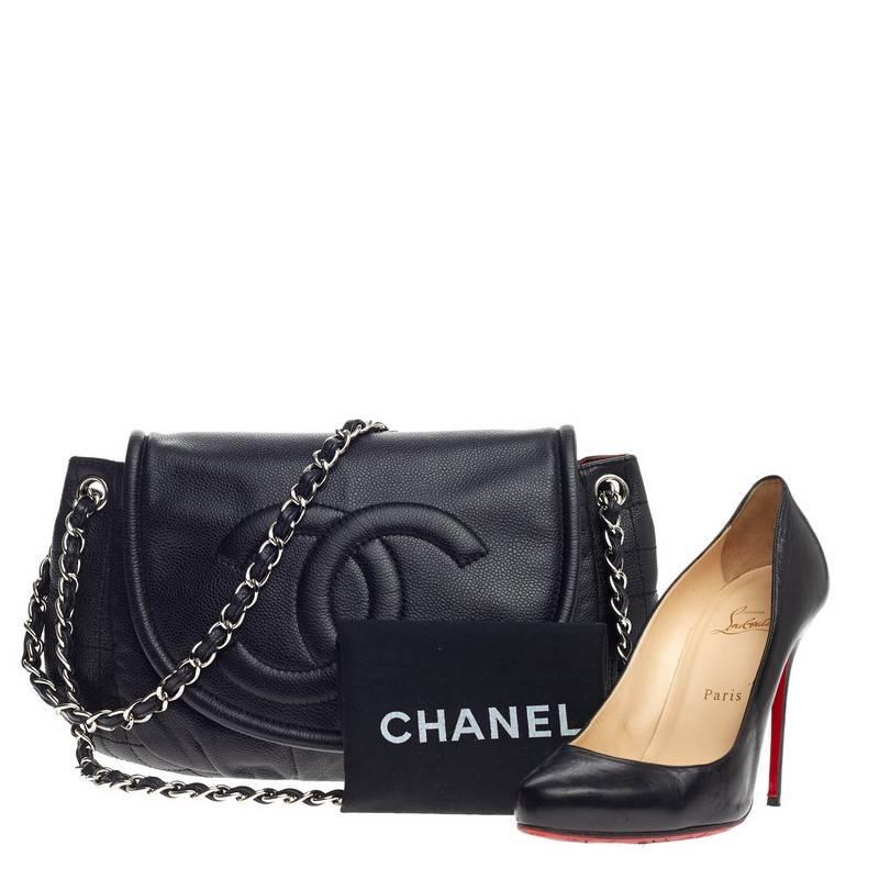 This authentic Chanel Timeless Half Moon Flap Caviar Large is sophisticated and tasteful piece that can be carried during day to night. Crafted from classic black caviar leather, this pleated half-moon shape flap bag features signature woven-in