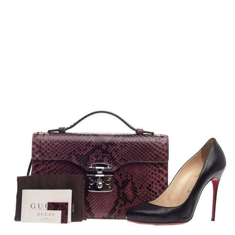 This authentic Gucci Lady Lock Briefcase Clutch Python is the perfect small accessory for work or night out. Crafted in purple genuine python skin, this briefcase features top handle, lady lock closure, frontal flap, leather clochette and