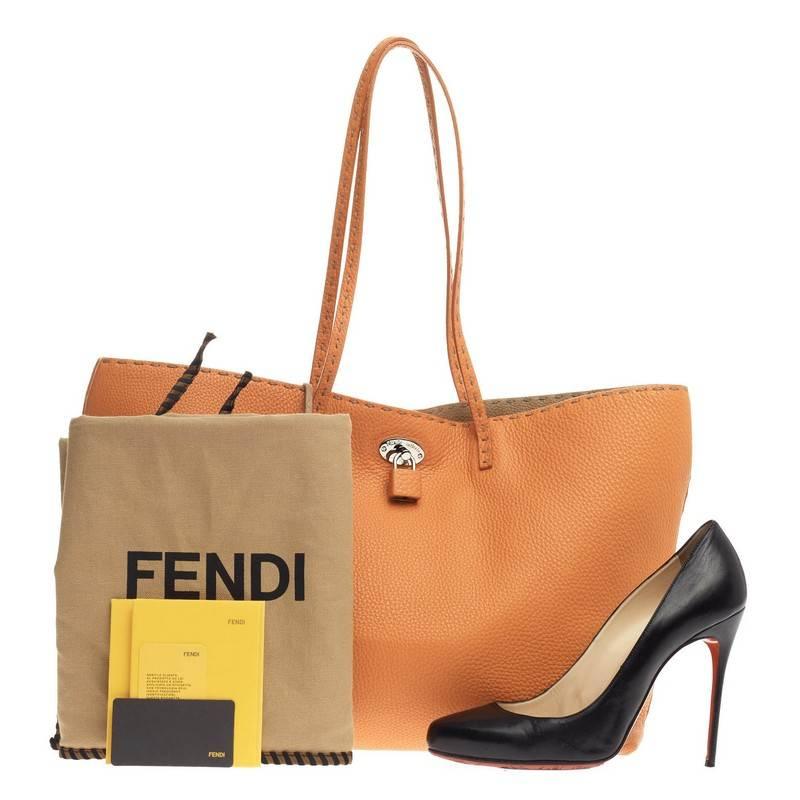 This authentic Fendi Carla Tote Selleria Leather Large is a signature and iconic tote made for everyday excursions. Crafted from orange selleria leather, this beautiful bag features hand-stitched flat leather top handles, signature