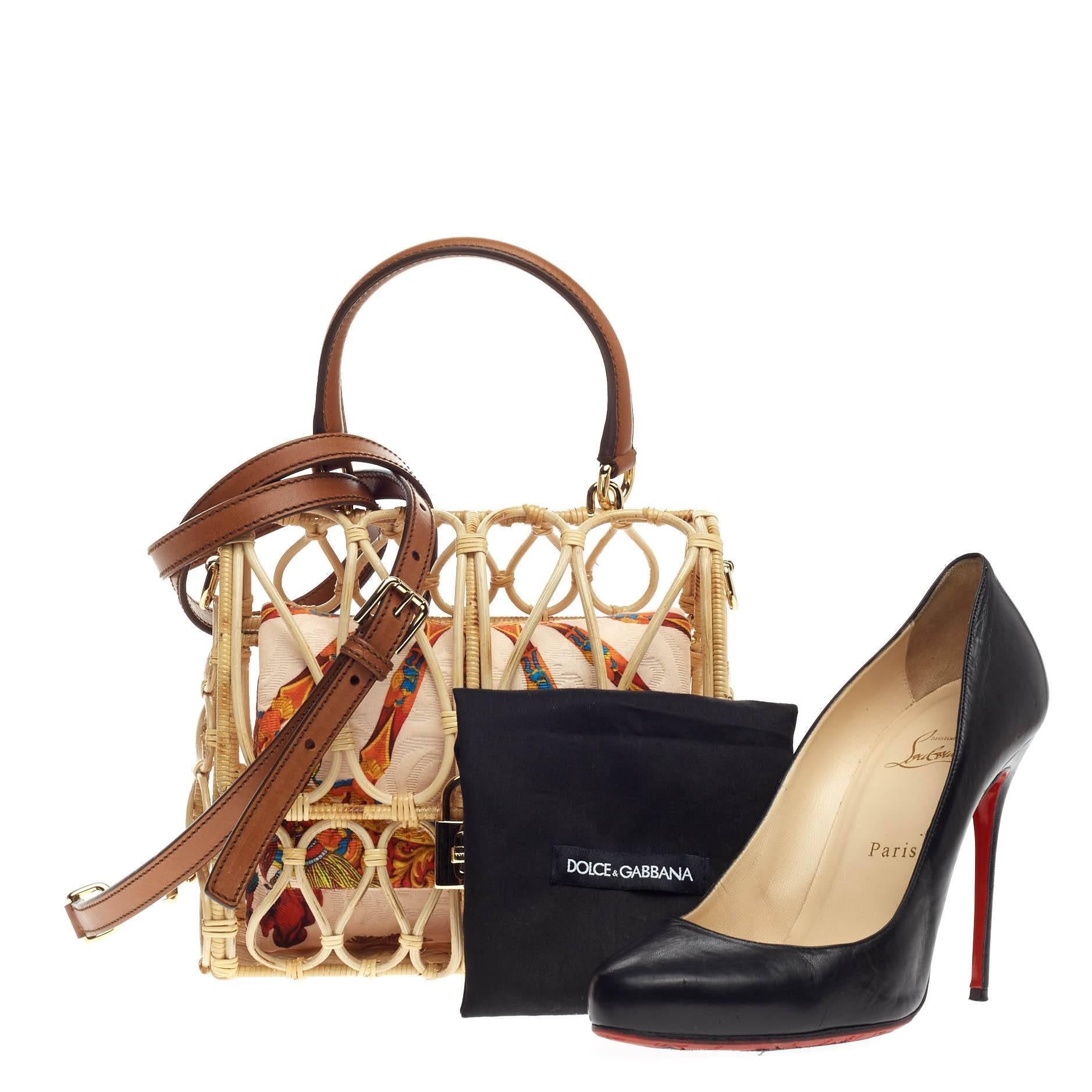 This authentic Dolce & Gabbana Birdcage Bag Rattan presented in the brand's Spring/Summer 2014 Runway Collection is an excellently crafted collector's piece made for the modern woman. Crafted in hand-worked rattan inspired by a birdcage which serves