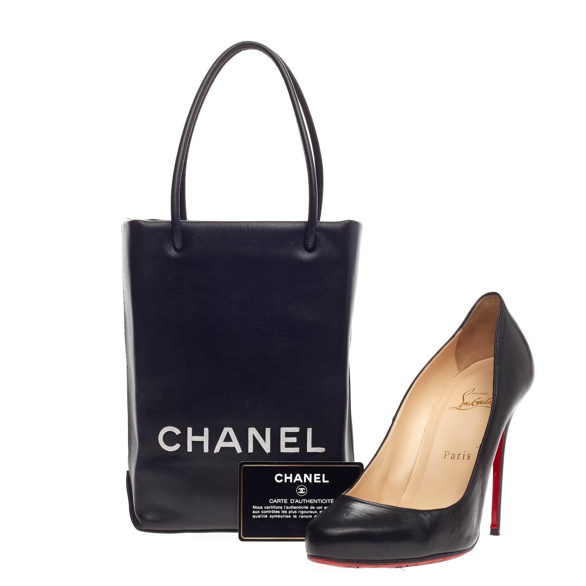 This authentic beautiful Chanel Essential Shopping Tote Leather Small is the perfect petite accessory that compliments any outfit. Crafted from black smooth leather, this miniature handle bag features dual-rolled thin straps, printed Chanel logo at