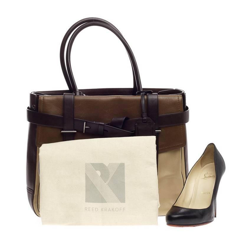This authentic Reed Krakoff Tricolor Boxer Tote Leather Large is a versatile structured bag that complements both dressy and casual looks perfect for the modern woman. Constructed in beautiful, tricolor neutral shades of brown, this functional tote