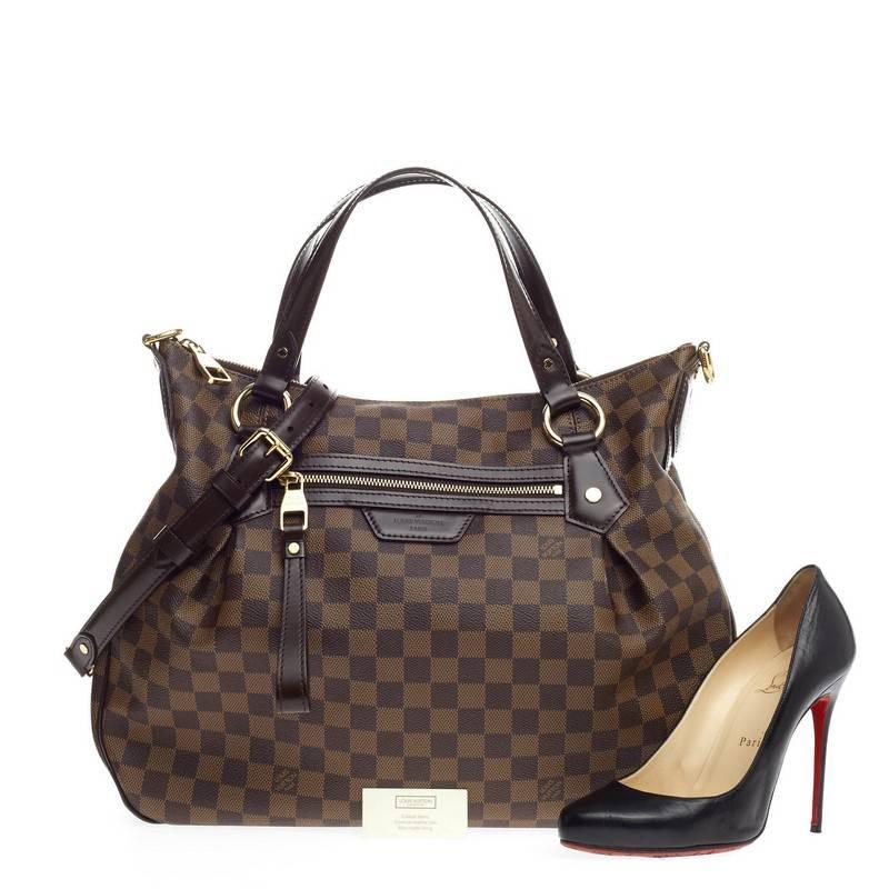 This authentic Louis Vuitton Evora Damier MM displays understated simplicity and elegance with versatile functionality made for the modern woman. Crafted from Louis Vuitton's popular damier ebene canvas, this spacious, everyday tote features dual