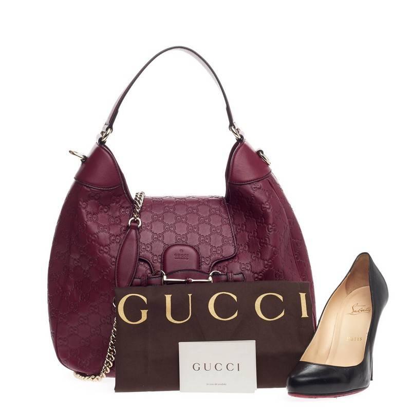 This authentic Gucci Emily Hobo Guccissima Leather Medium is a stylish accessory perfect for everyday casual looks. Crafted in ruby red guccissima leather, this modern-day hobo features Gucci's iconic horsebit design with leather tassels at the